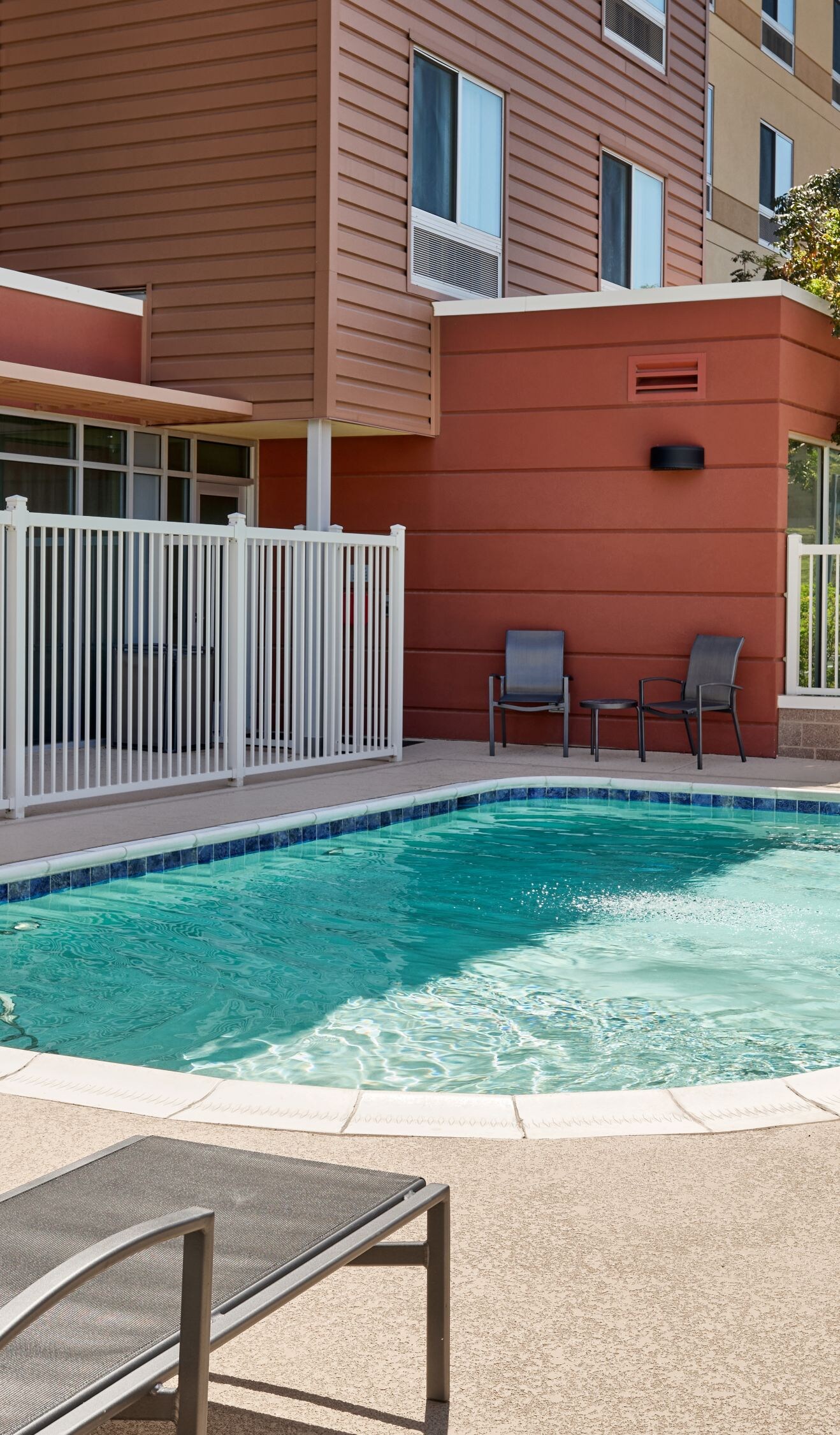 Outdoor pool with lounge chairs and lift