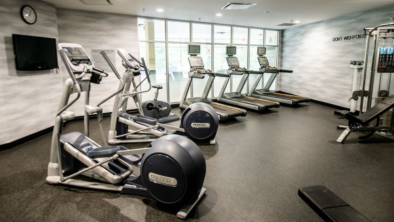 Fitness Center with machines, weights, and TV