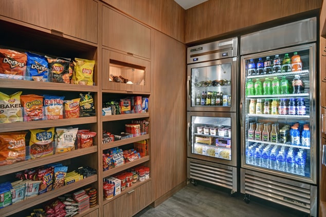 Fridge with drinks, shelves with food & snacks