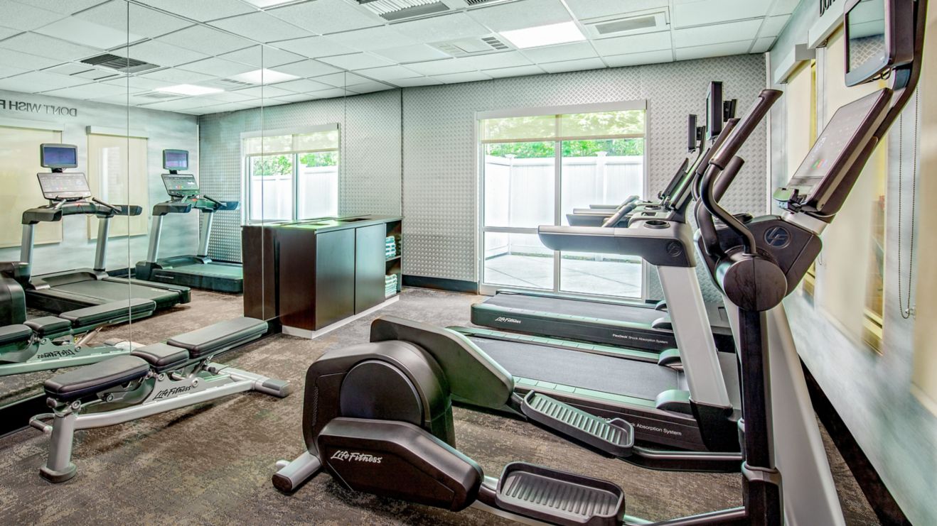 A bright room with mirror and fitness equipment 