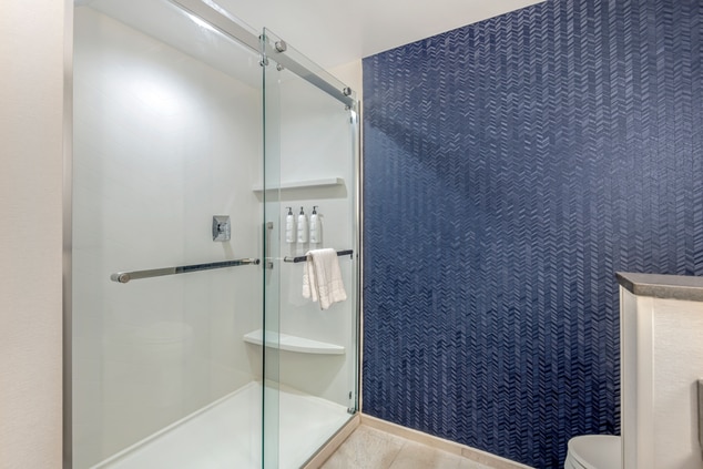 bathroom with walk in shower and toilet