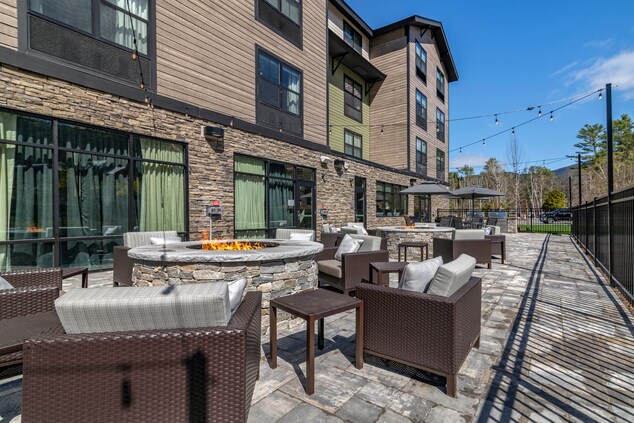 patio with chairs, and 2 fire pits