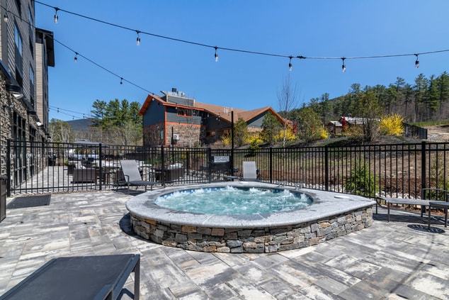 hot tub on outdoor patio with mountain in back