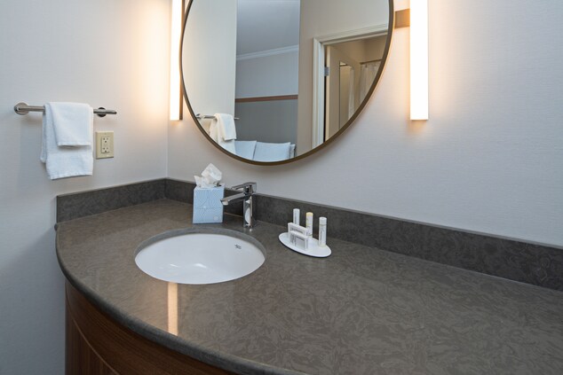 Sink, mirror, towels, and toiletries