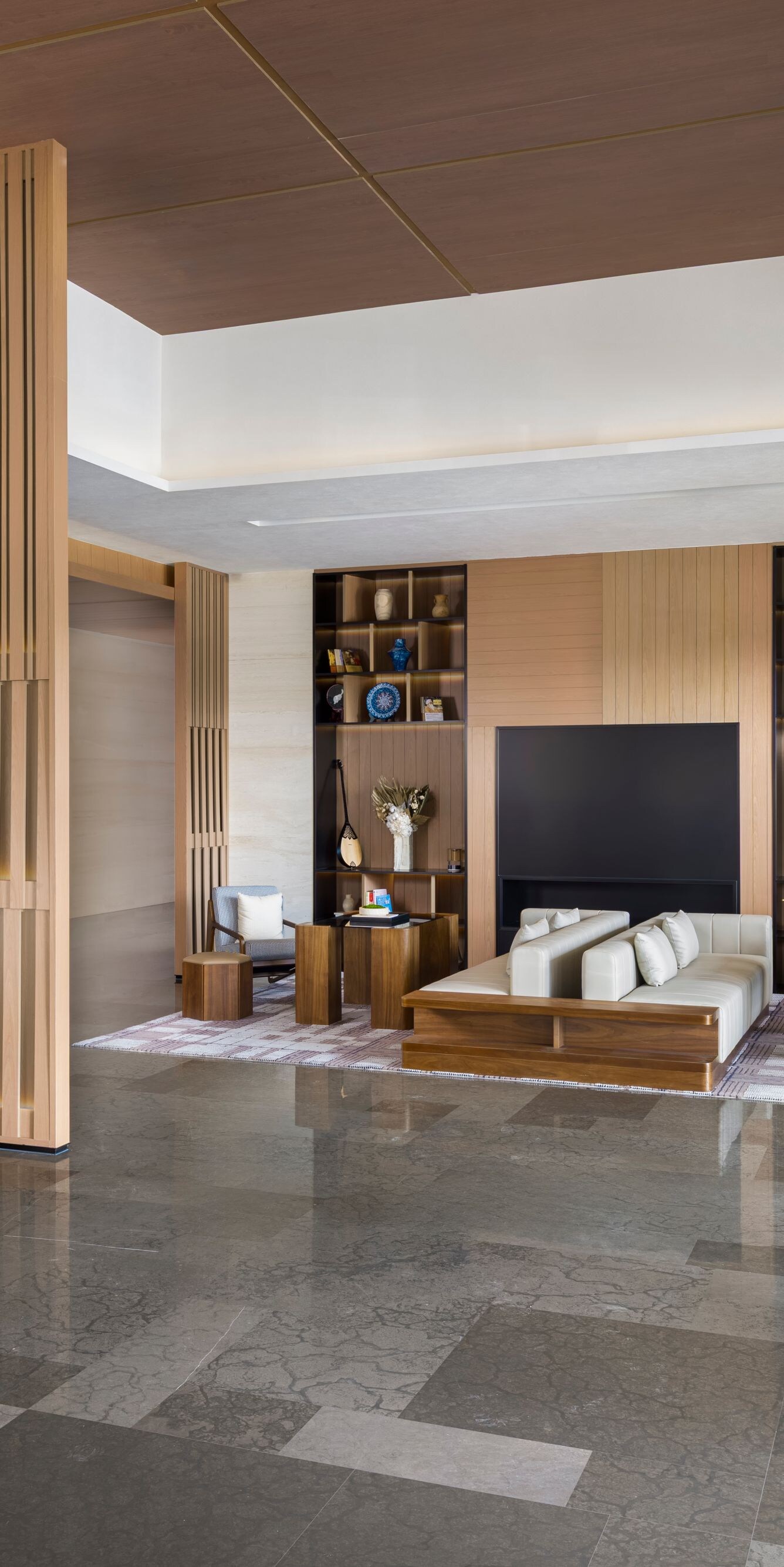 Spacious modern hotel lobby with seating and woode