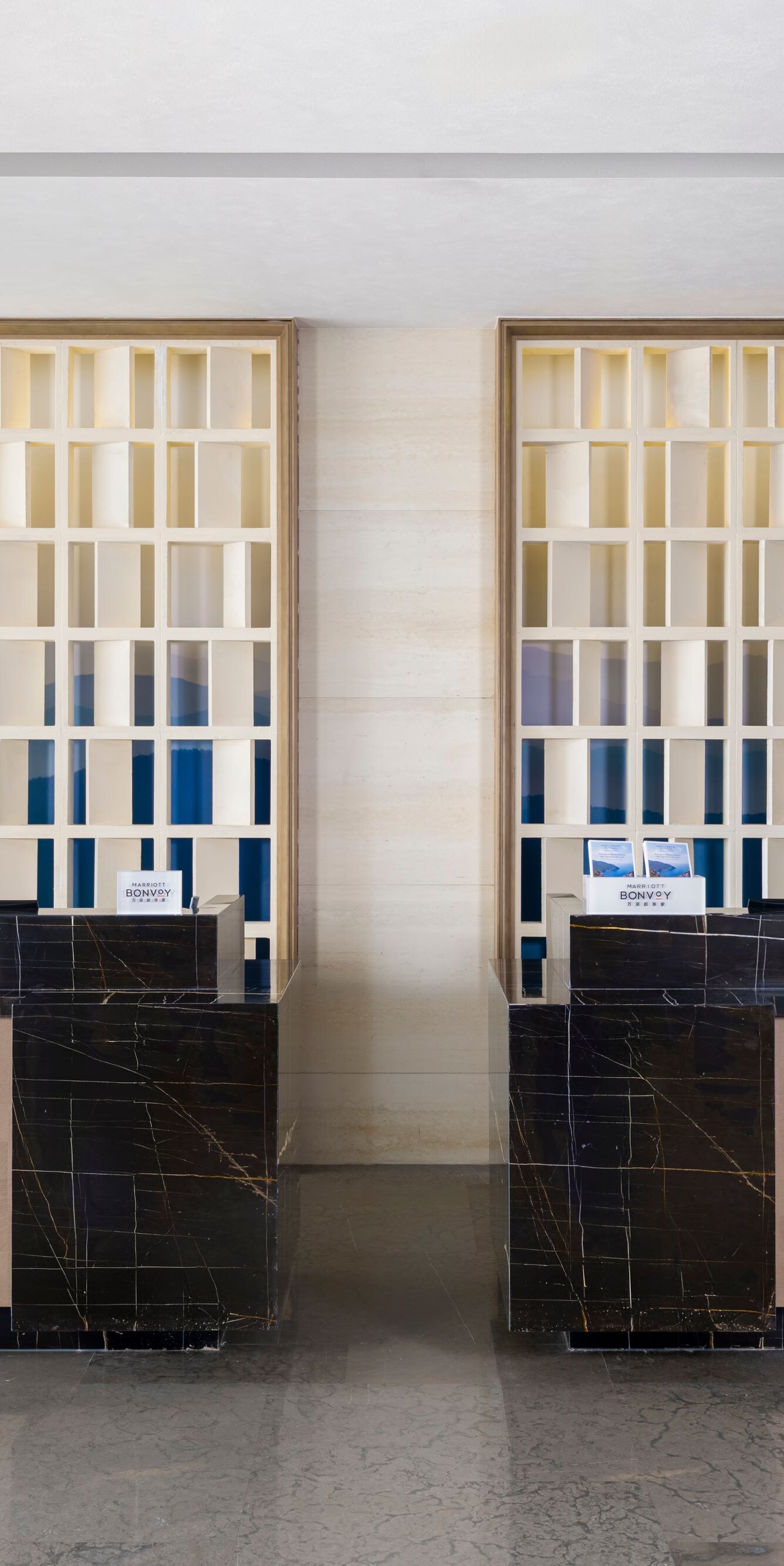 Modern hotel reception counter with decorative scr