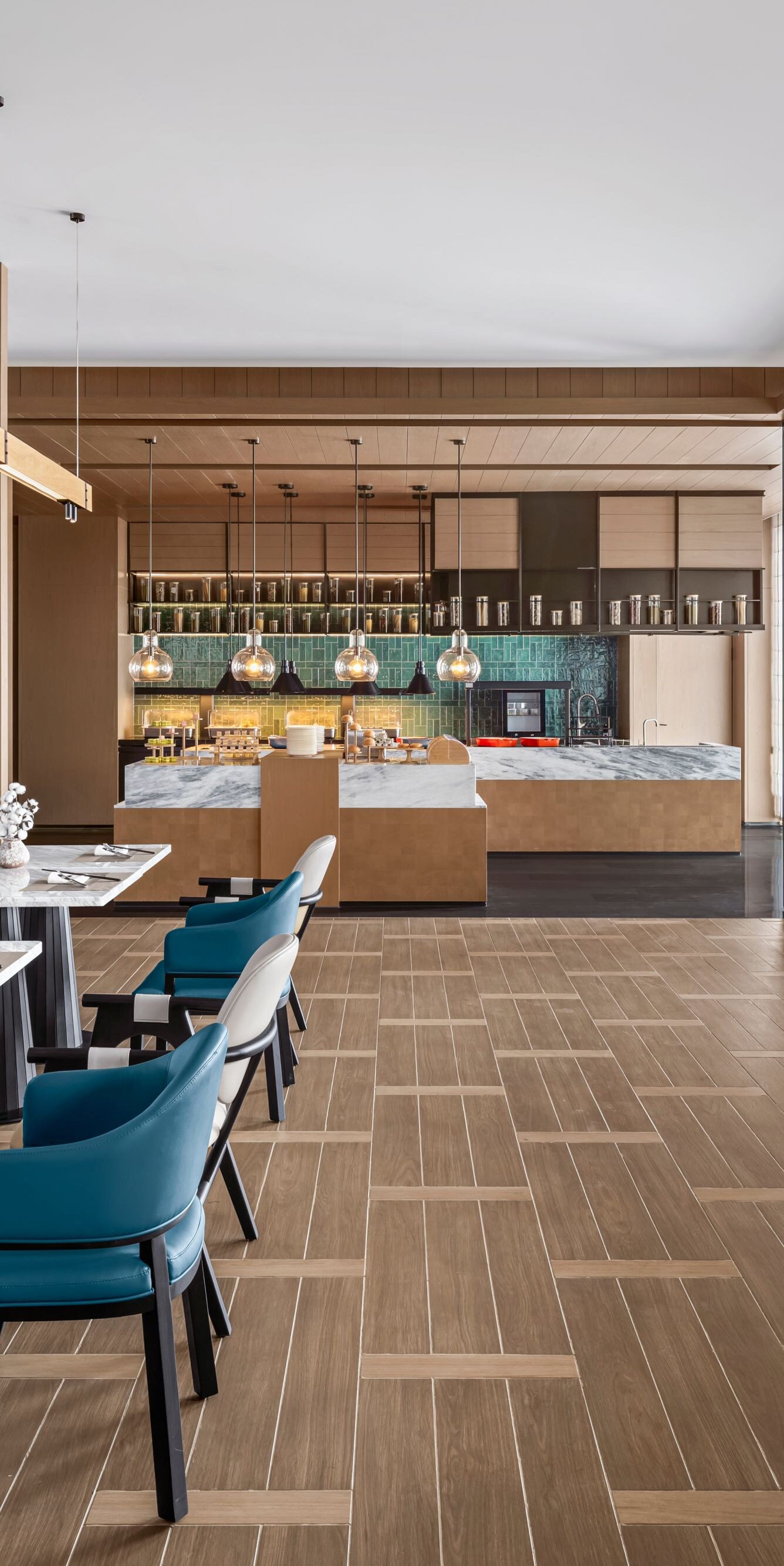 Bright modern hotel restaurant with dining tables 
