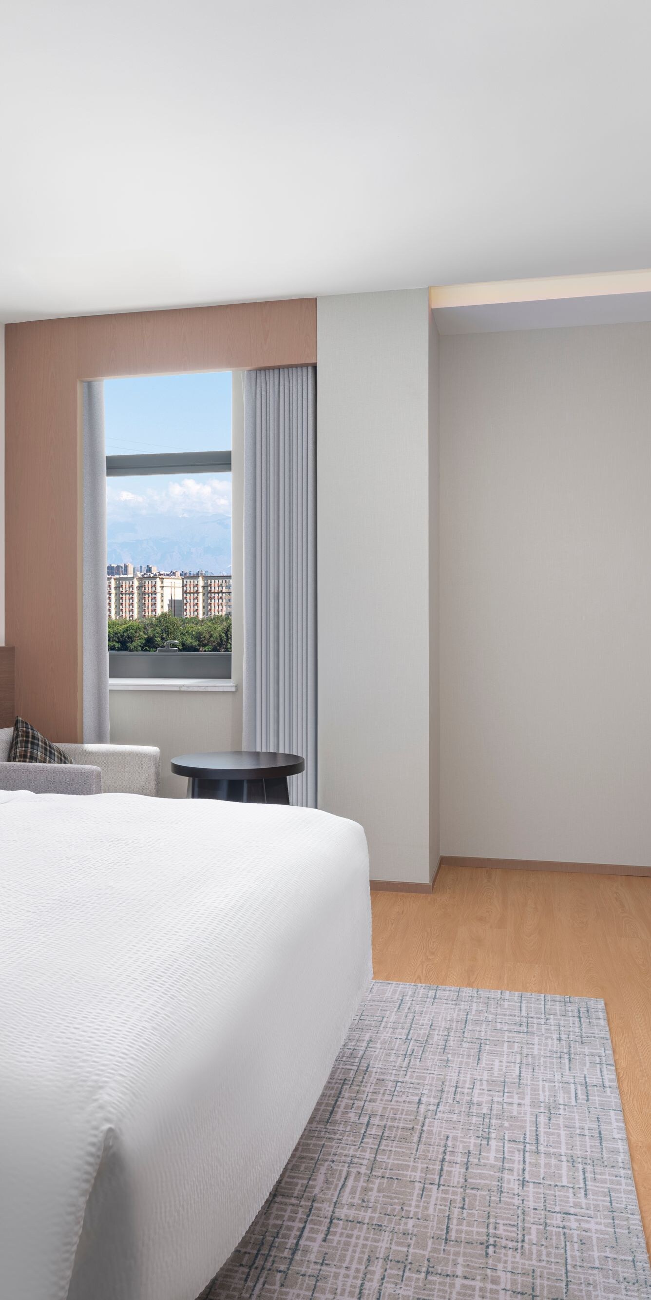 Bright suite bedroom with king bed and window view