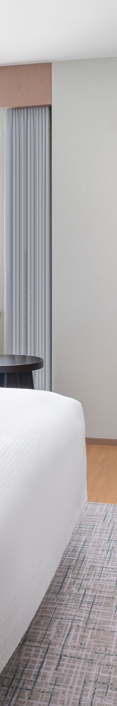 Bright suite bedroom with king bed and window view