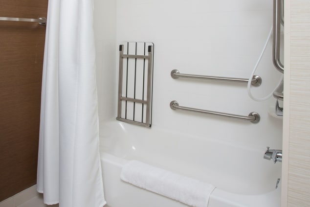 accessible shower/tub with handrails and seat