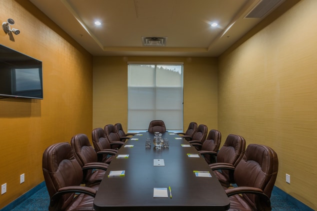 Boardroom table with 12 chairs and TV screen