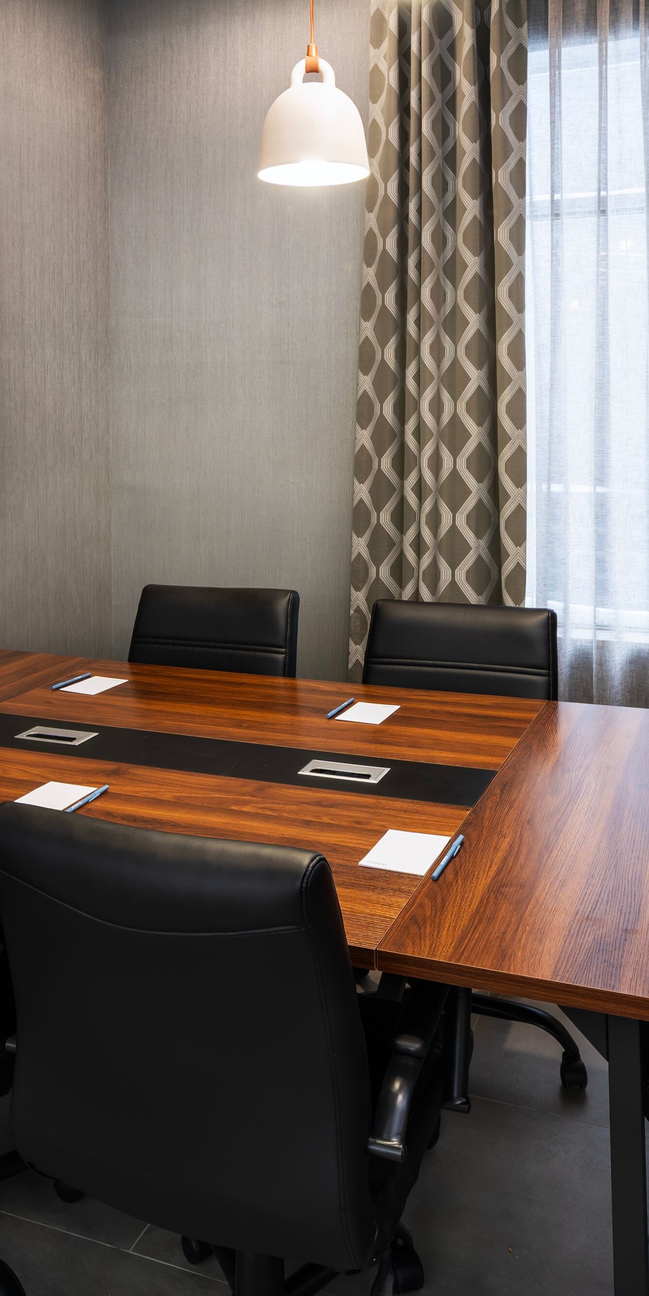 Meeting room with table and wall screen
