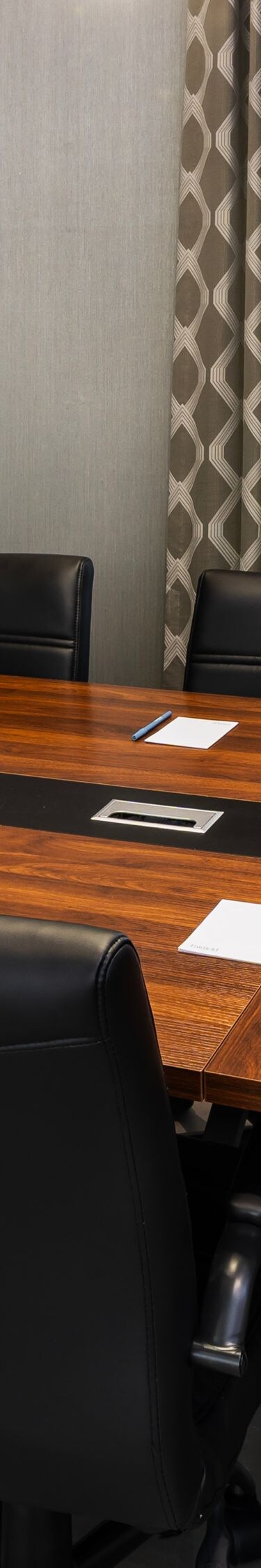 Meeting room with table and wall screen