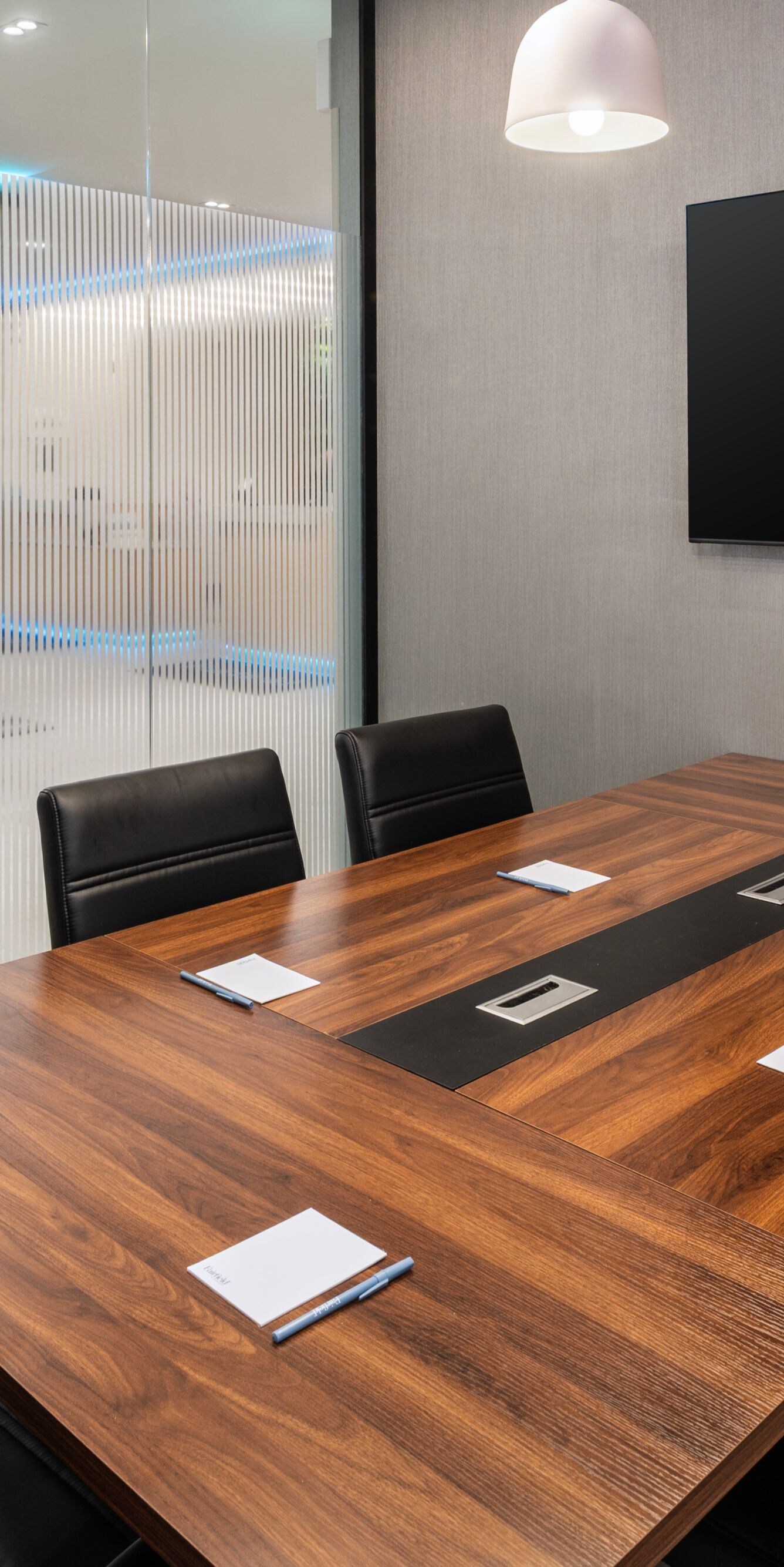 Meeting room with wood table and screen