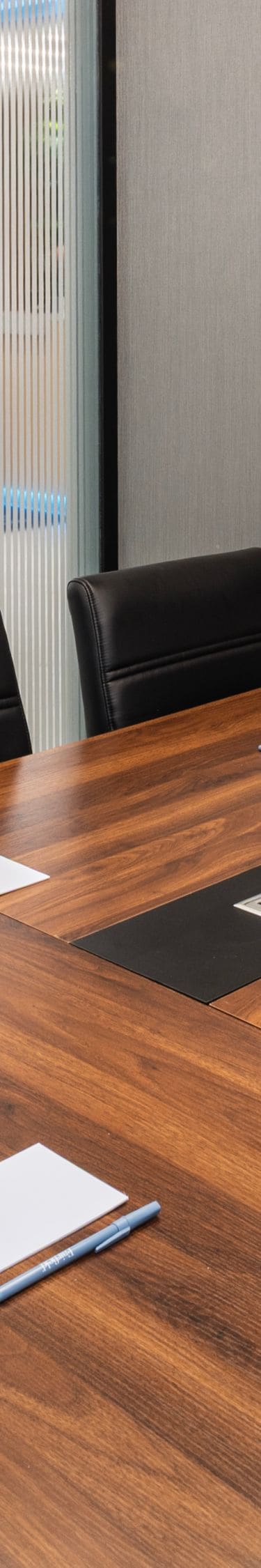 Meeting room with wood table and screen