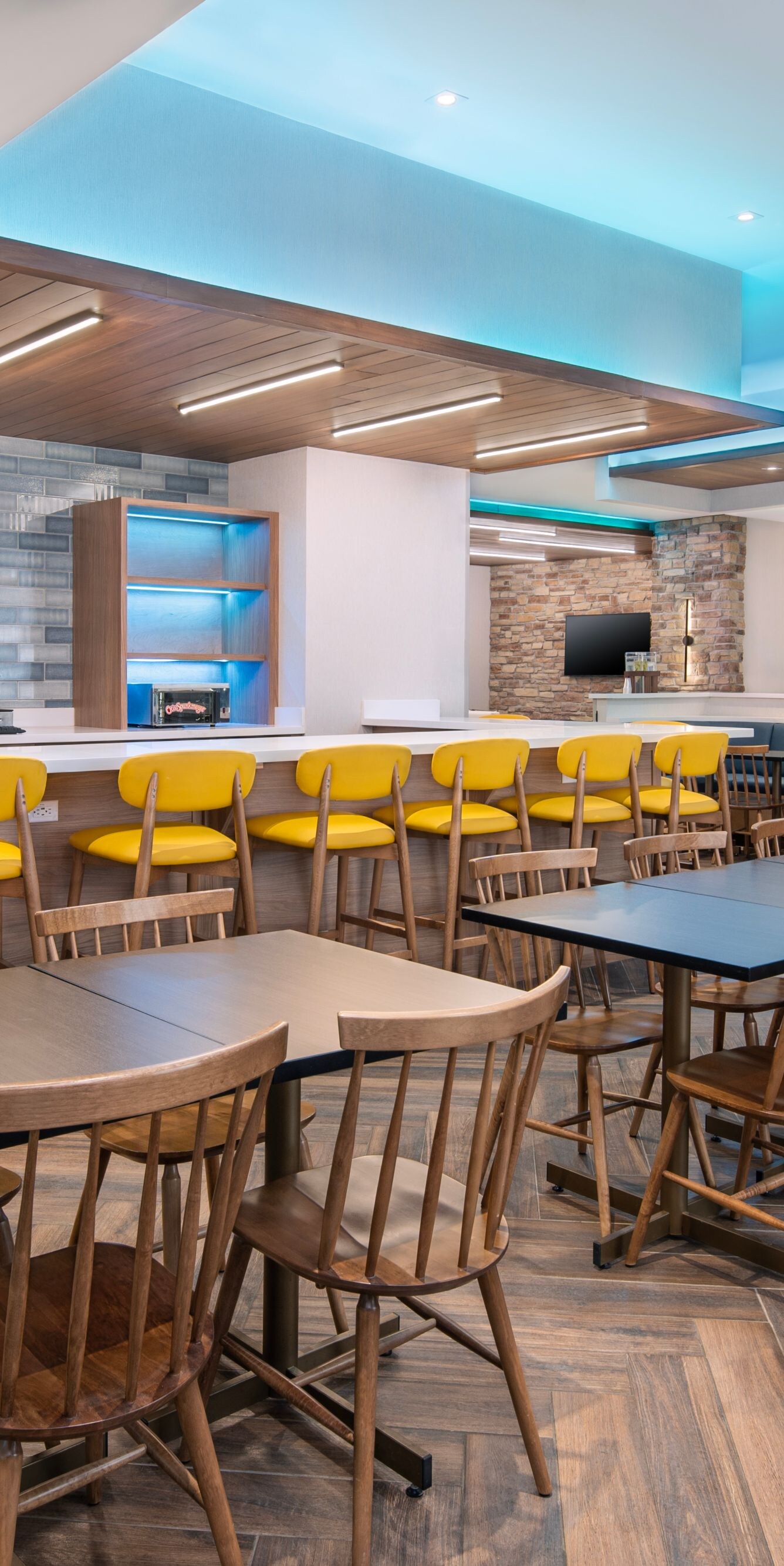 Modern dining area with yellow chairs