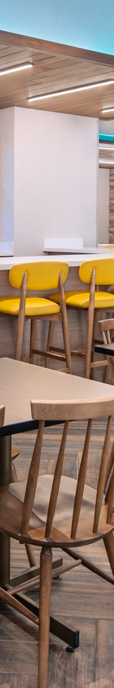 Modern dining area with yellow chairs
