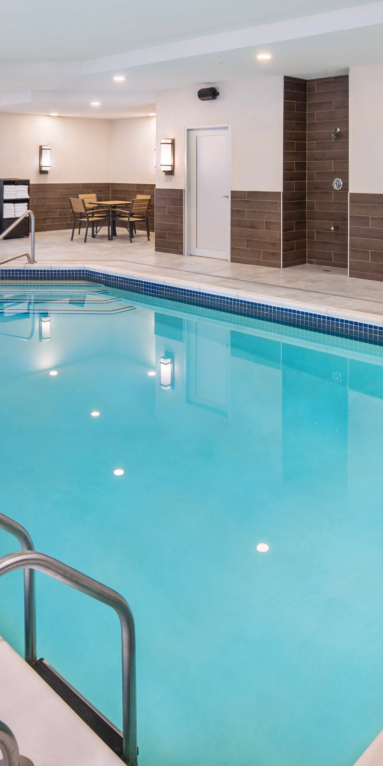Indoor pool with water feature and seating