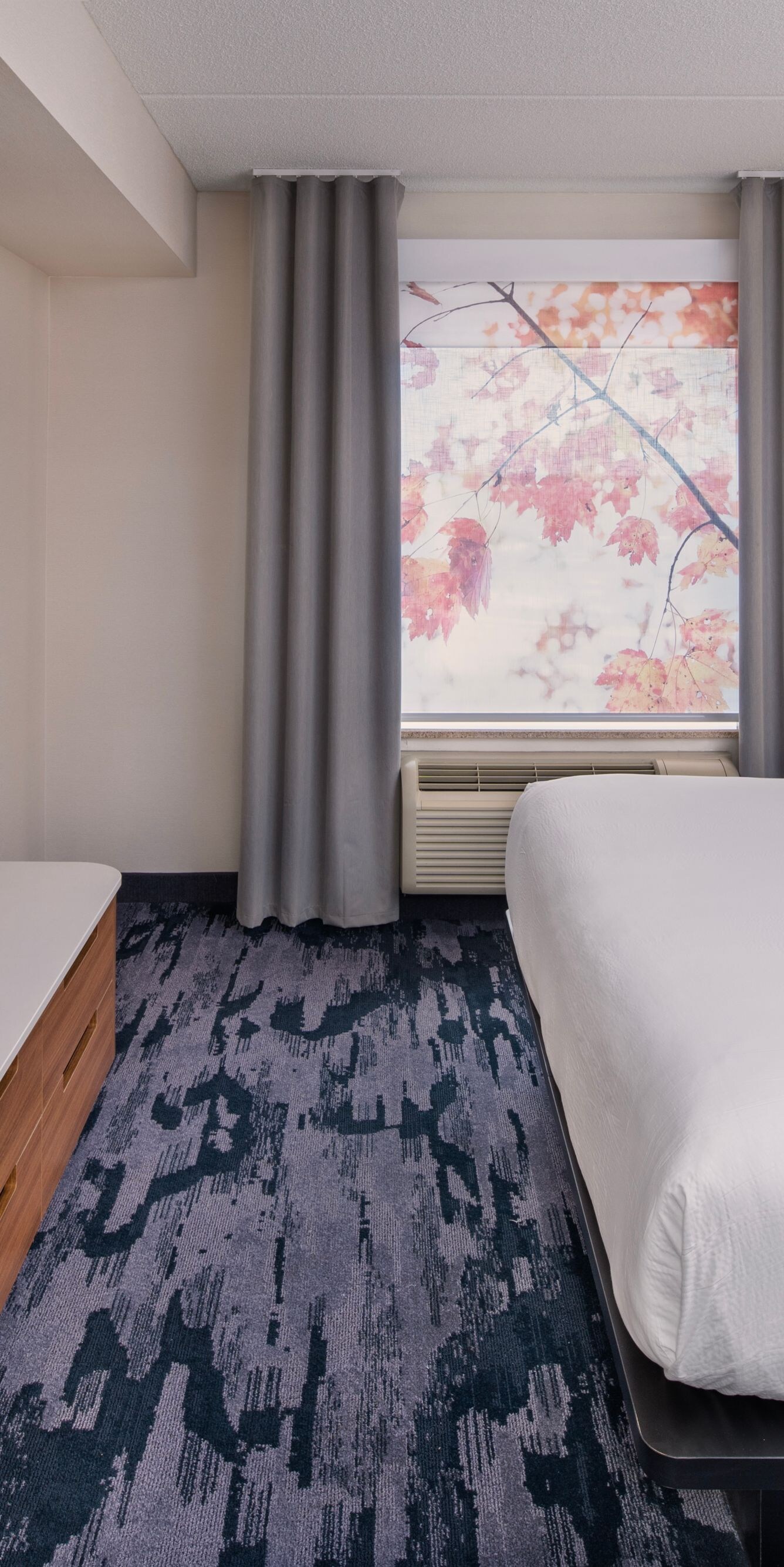 King guest room with autumn foliage view