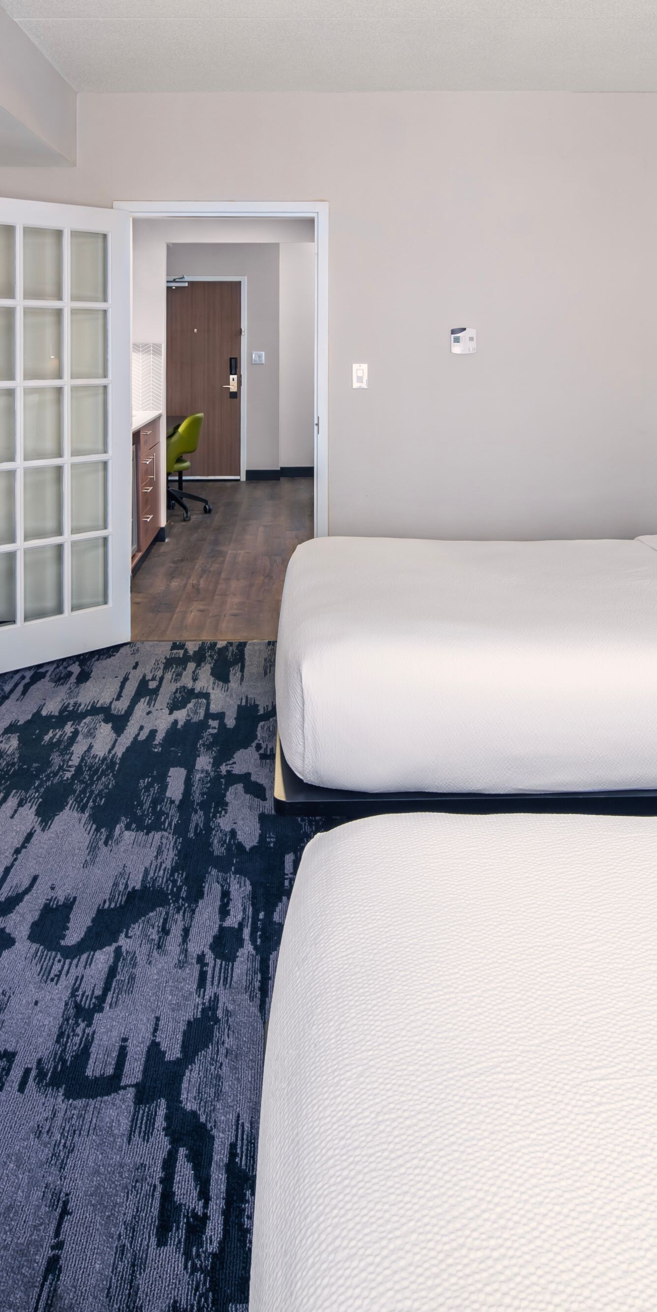 Double queen guest room with modern decor