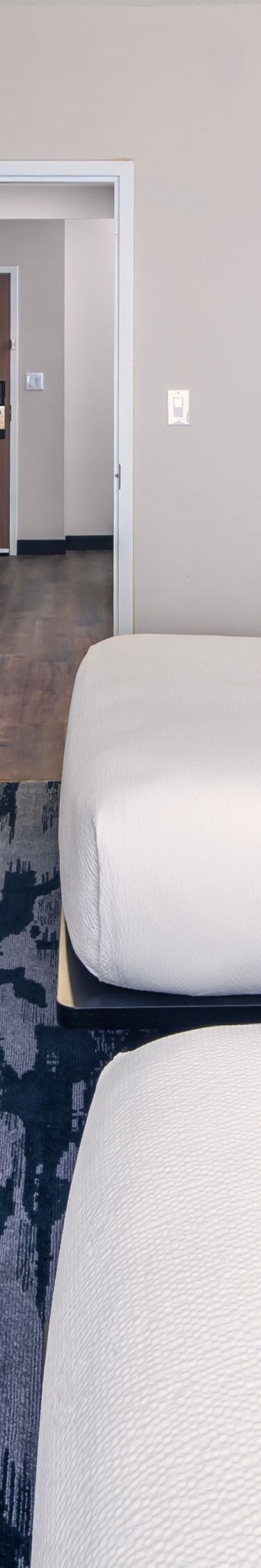 Double queen guest room with modern decor