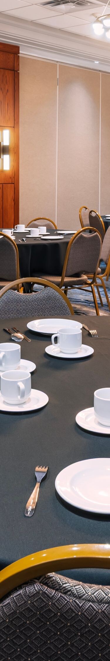 Ballroom with round tables and place settings
