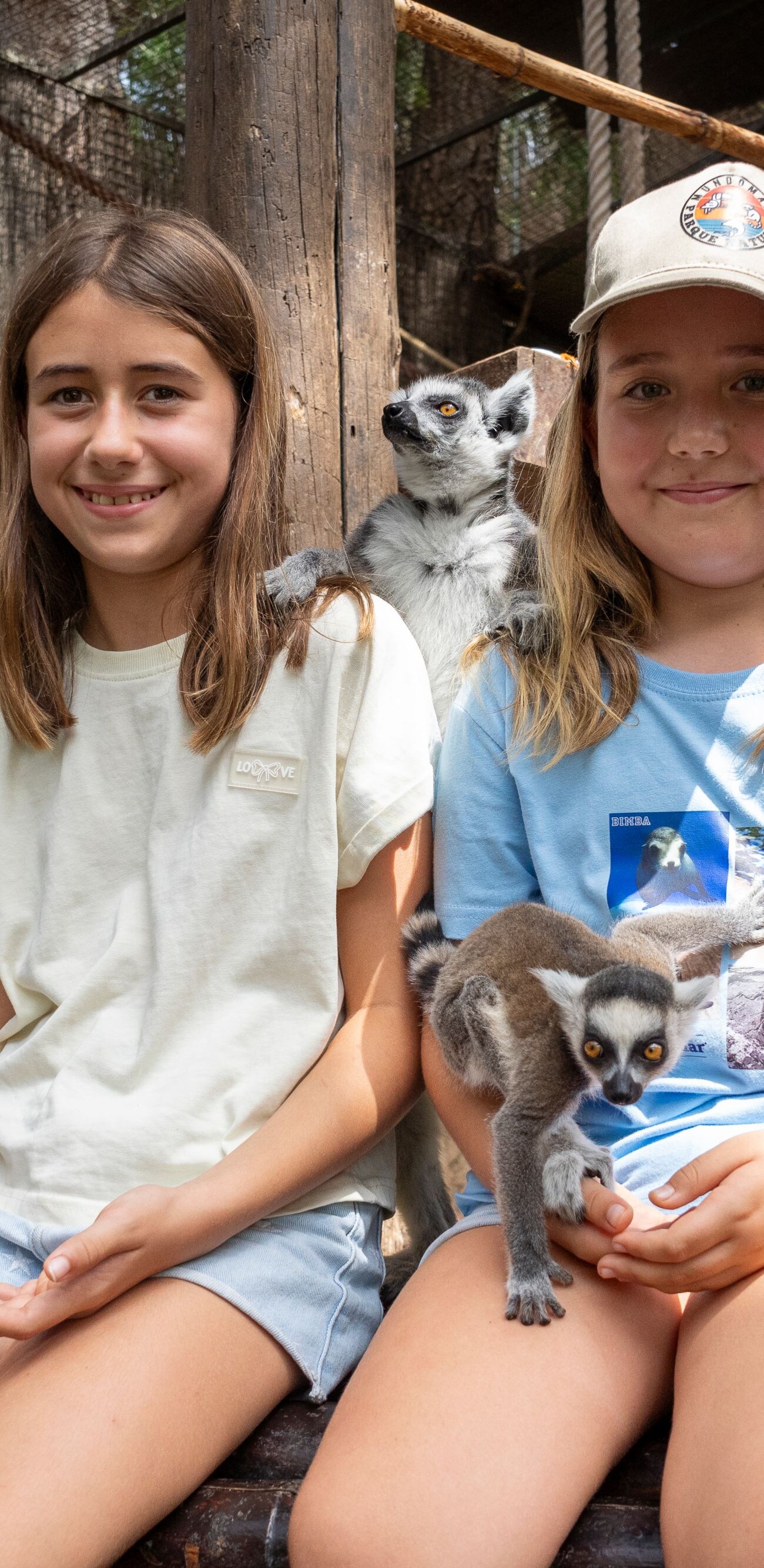 Children interacting with lemurs at Mundomar
