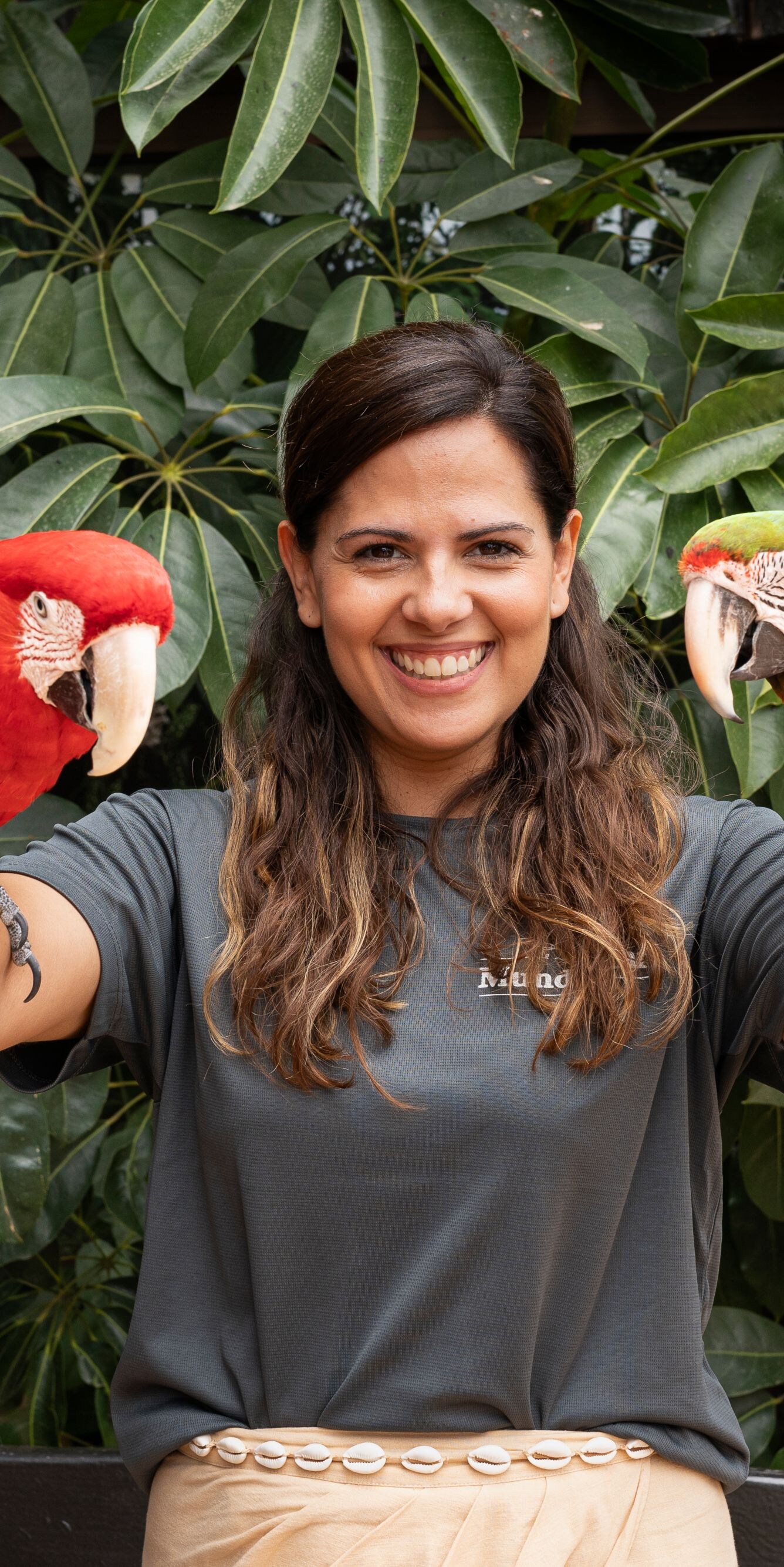 woman with parrot on each arm