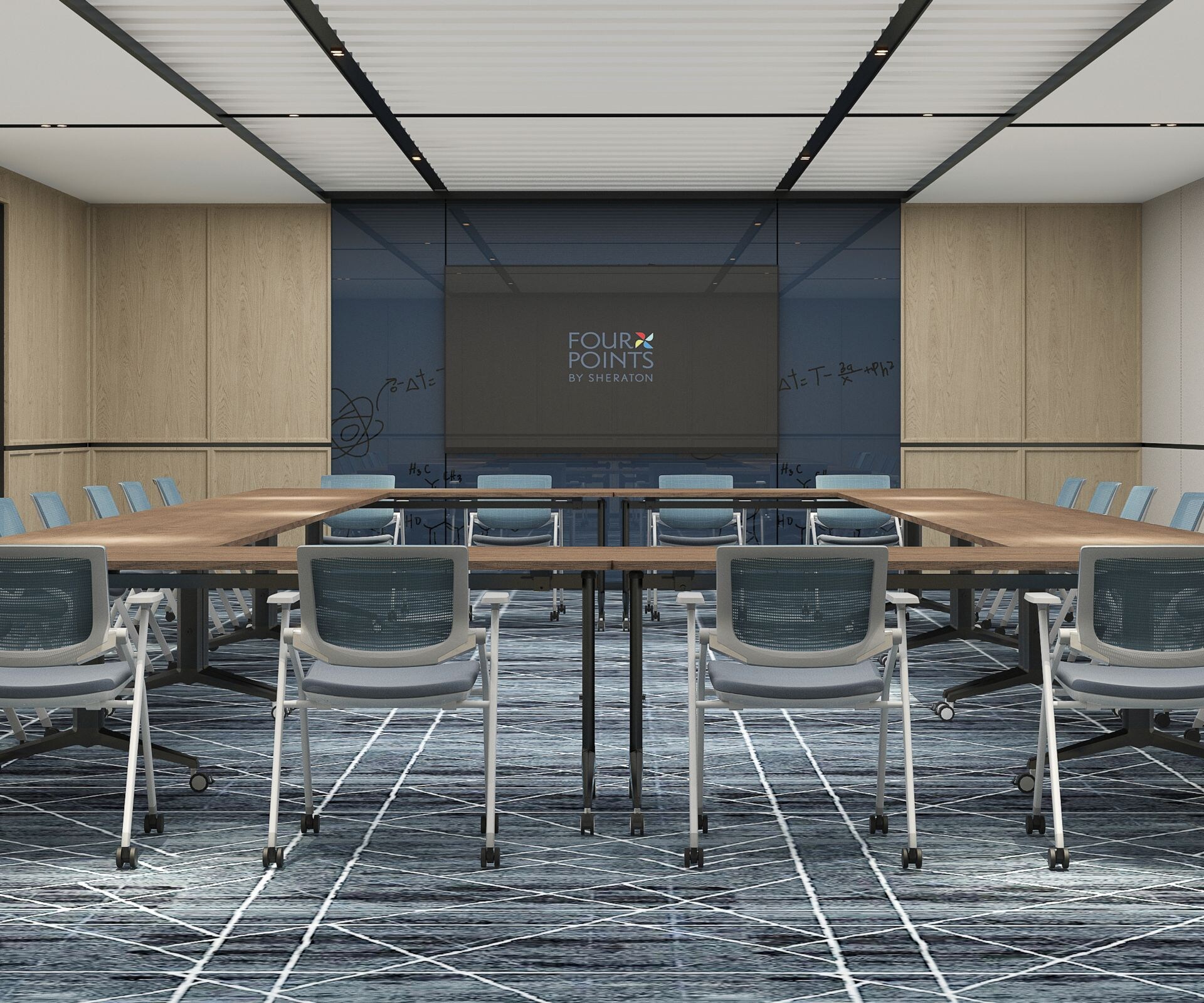 tables set up in u-shape with chairs and screen