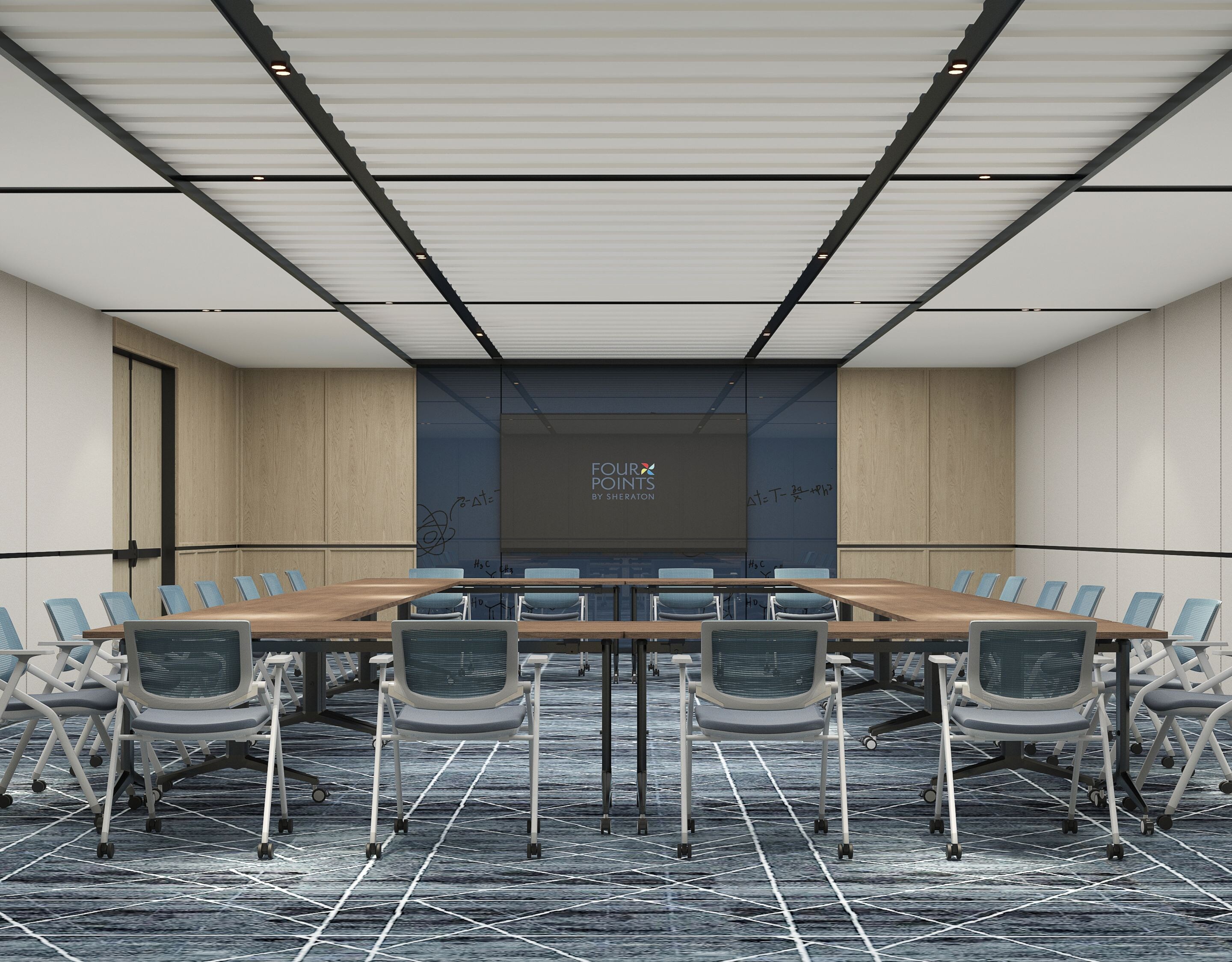 tables set up in u-shape with chairs and screen