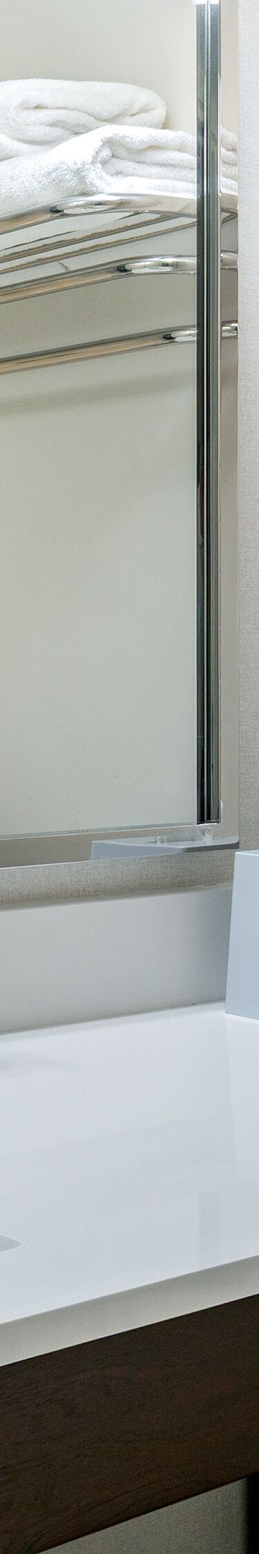 Guestroom bathroom with vanity and mirror 
