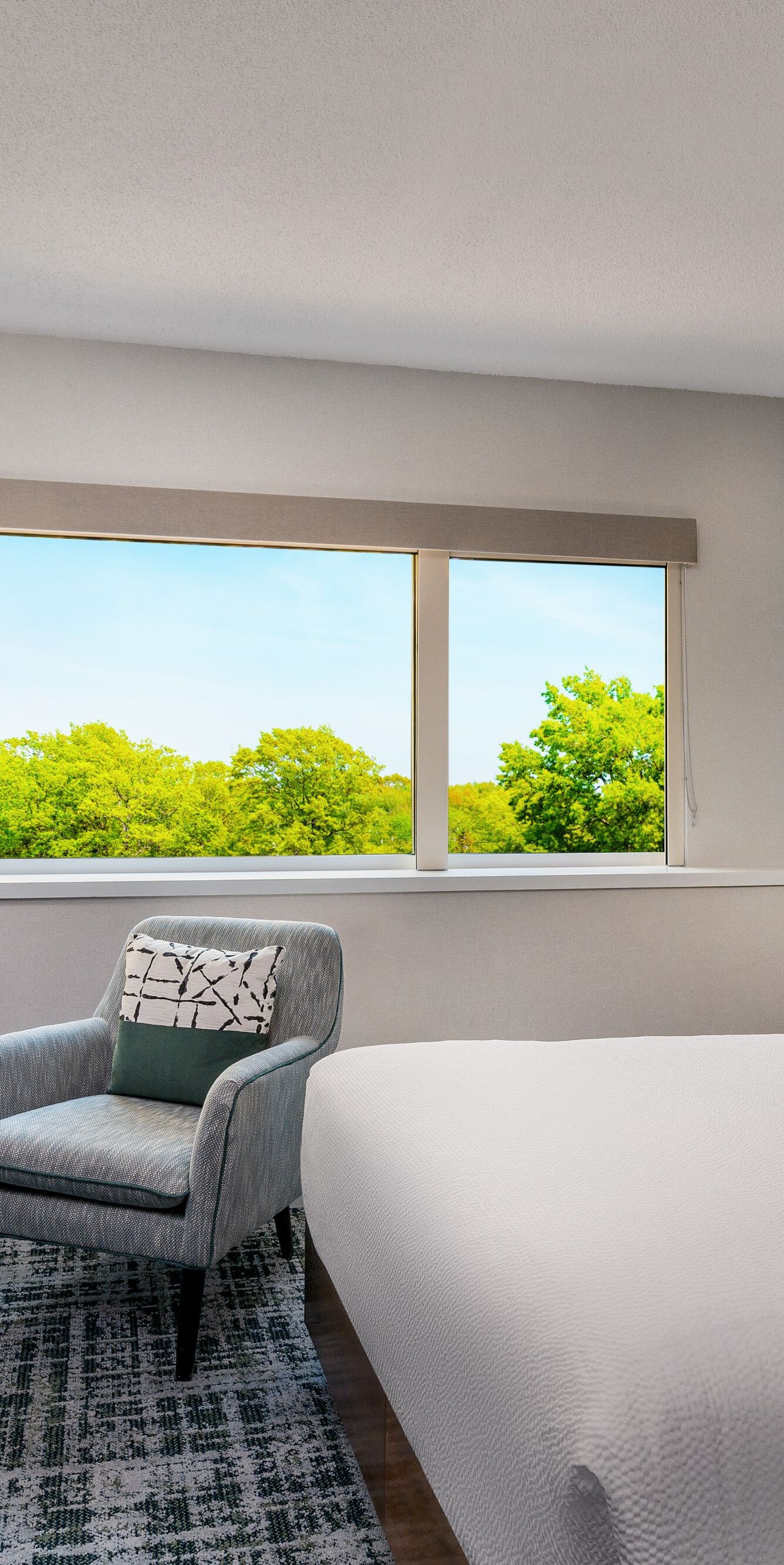 Hotel guest room with queen bed, work desk and TV