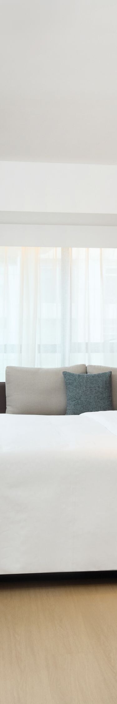 Spacious guest room with bed, tv, seating