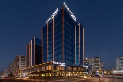 Hotel exterior at night with lit signage
