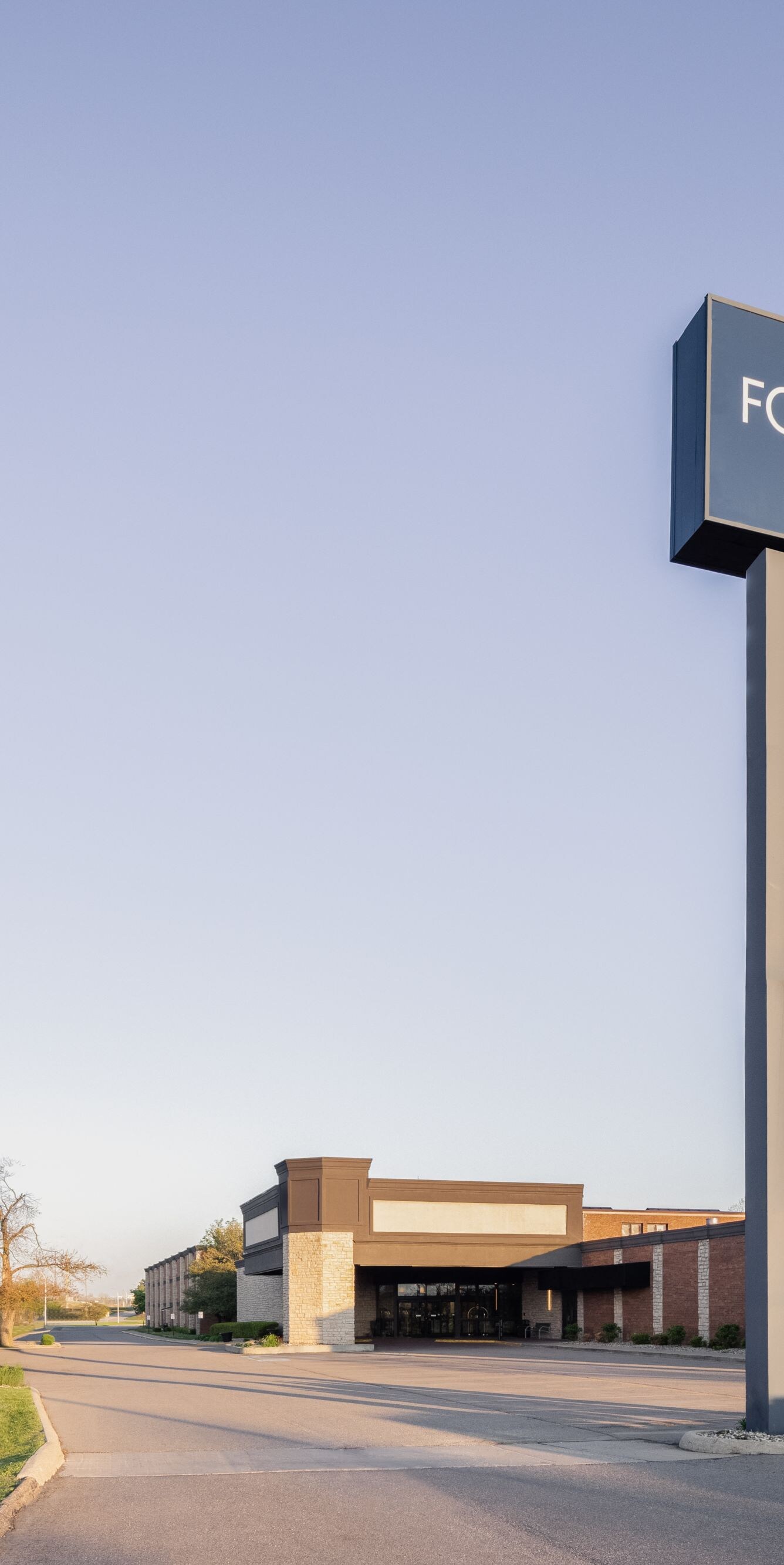 Exterior view of hotel with sign and flagpoles