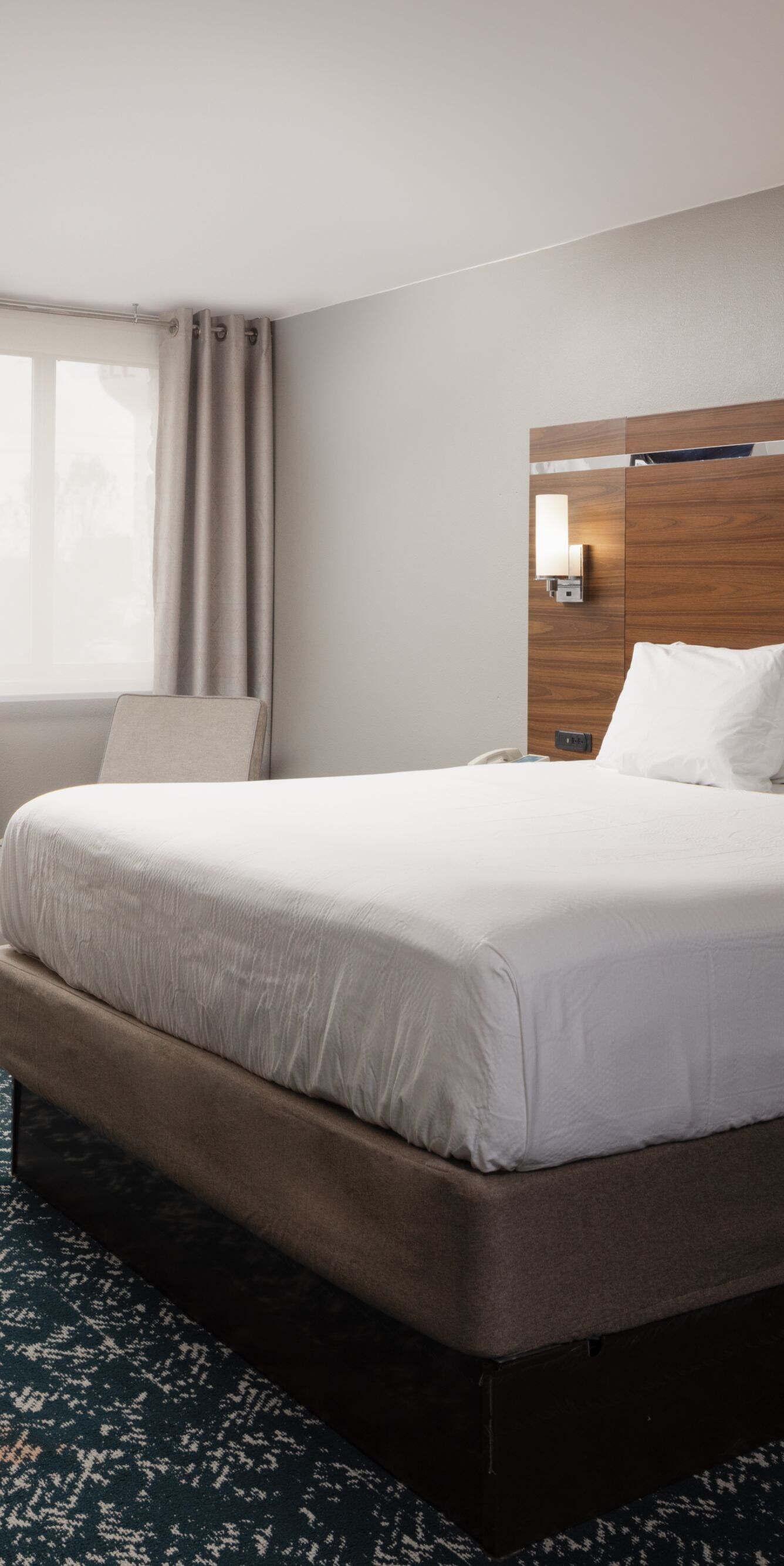 Guest room with king bed, desk, and lounge chair
