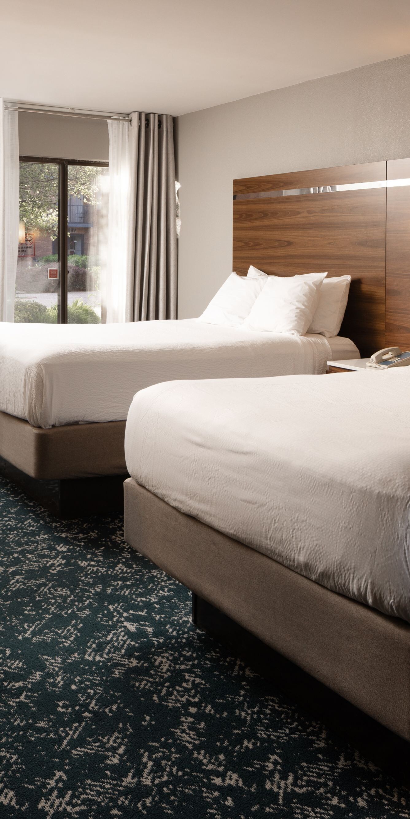 Guest room with two queen beds, desk, balcony
