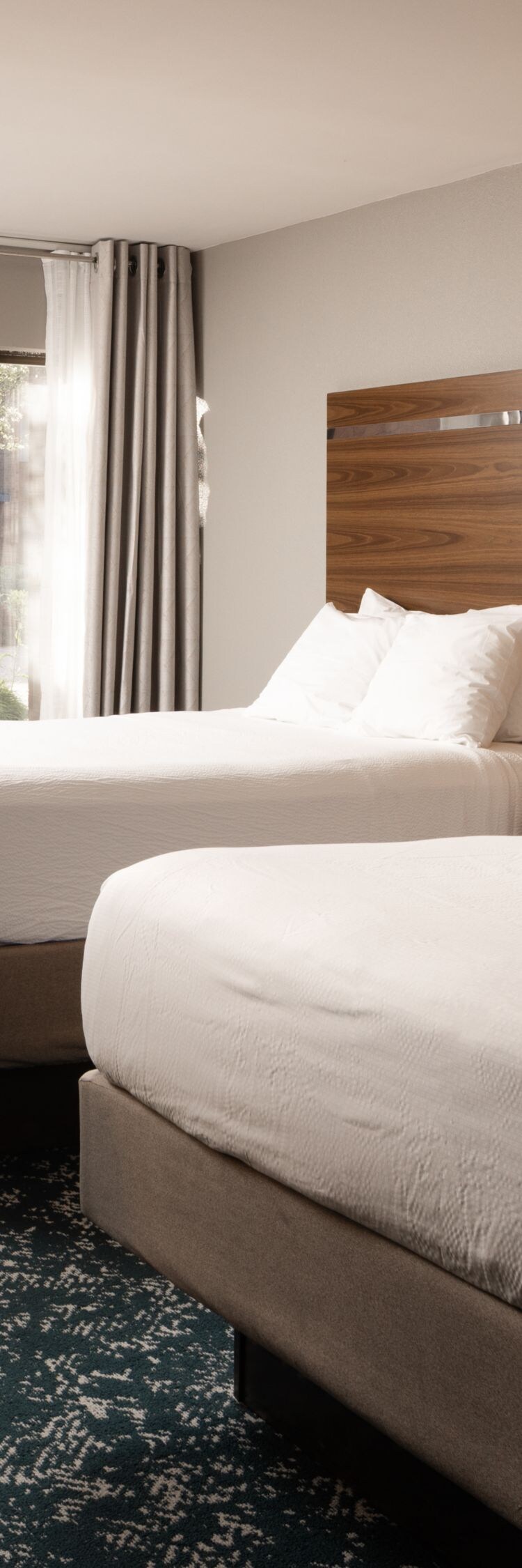 Guest room with two queen beds, desk, balcony