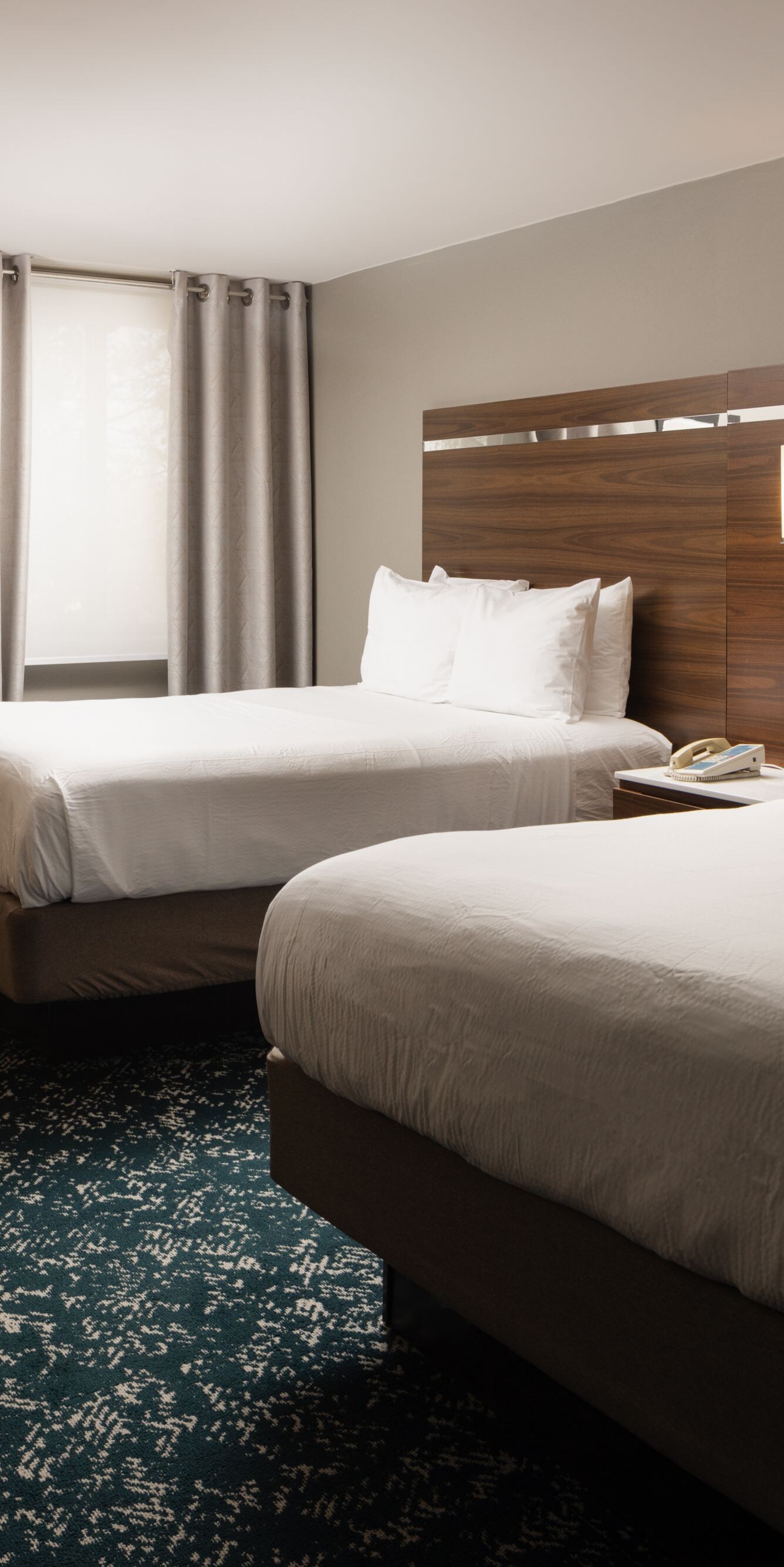 Guest room with two queen beds, desk