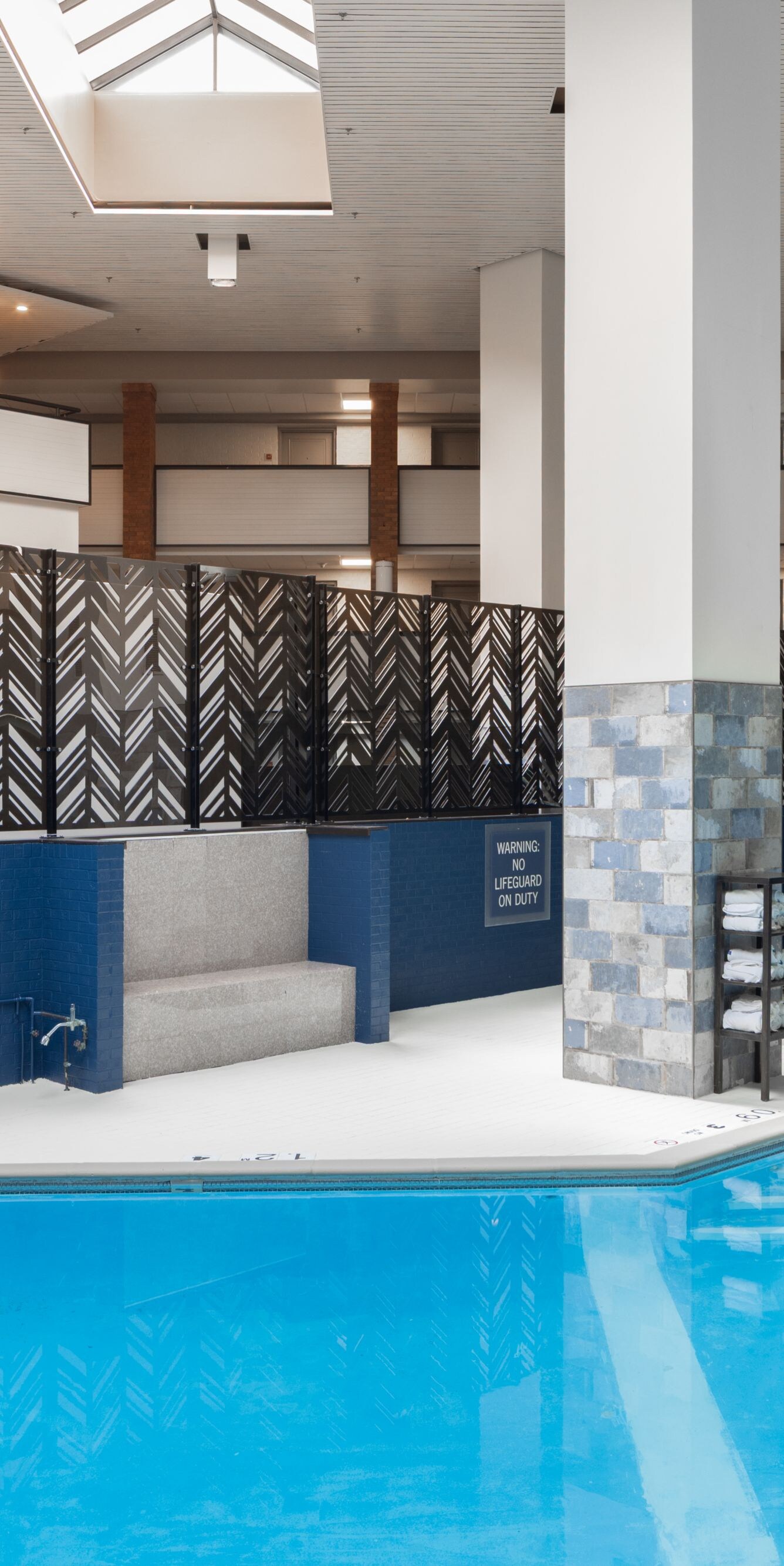 Indoor heated pool with stair and lift access.