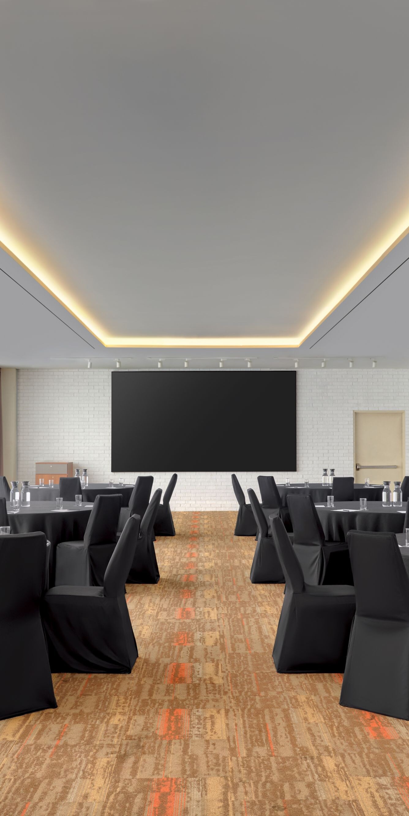 Meeting space with round tables and screen