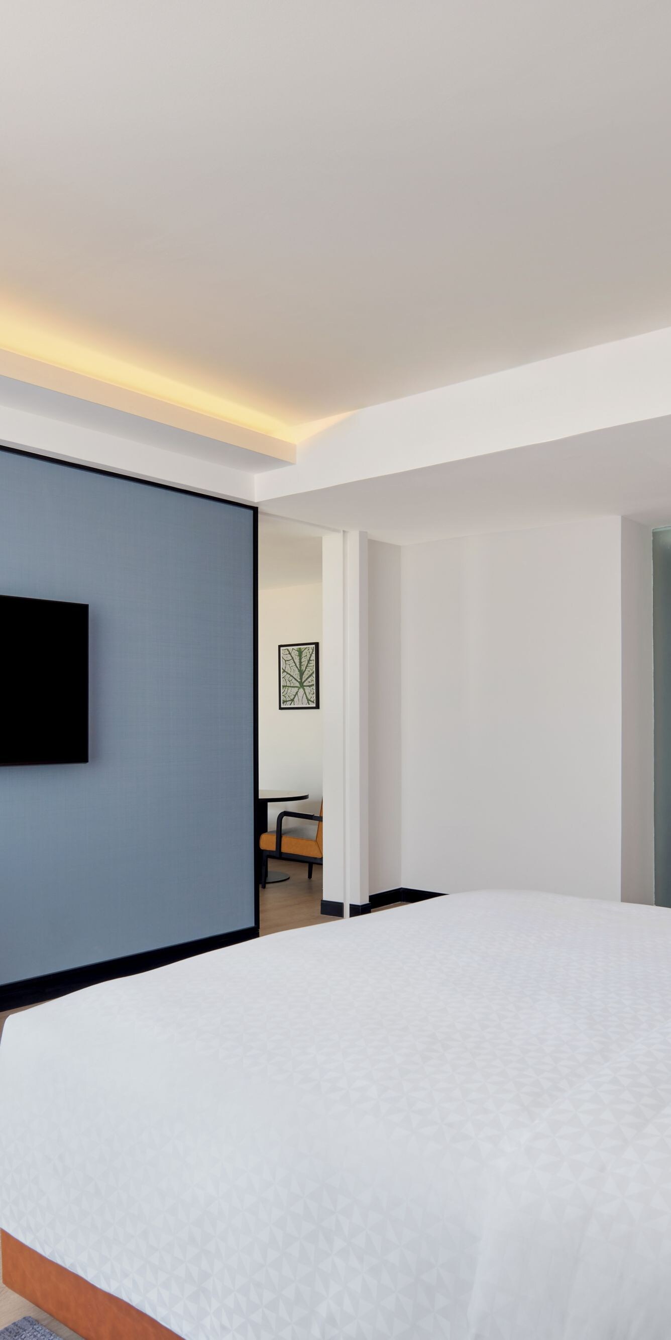 King guest room with desk and blue wall
