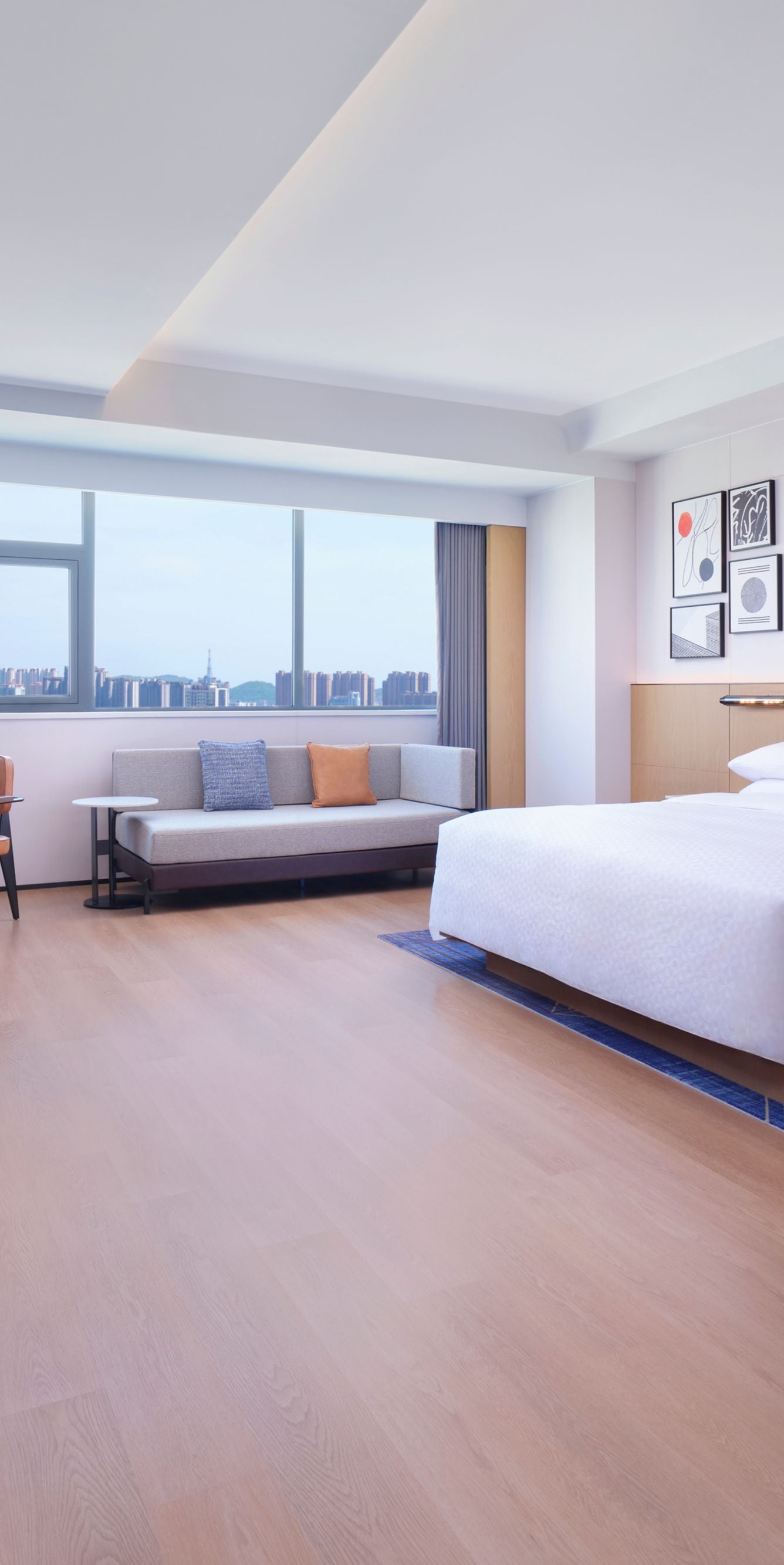 Hotel room with king bed, sitting area, and TV