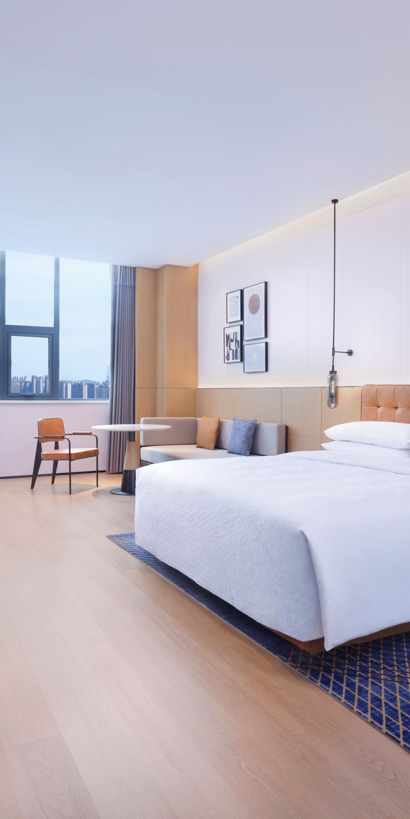 Suite with king bed, sitting area, and bench
