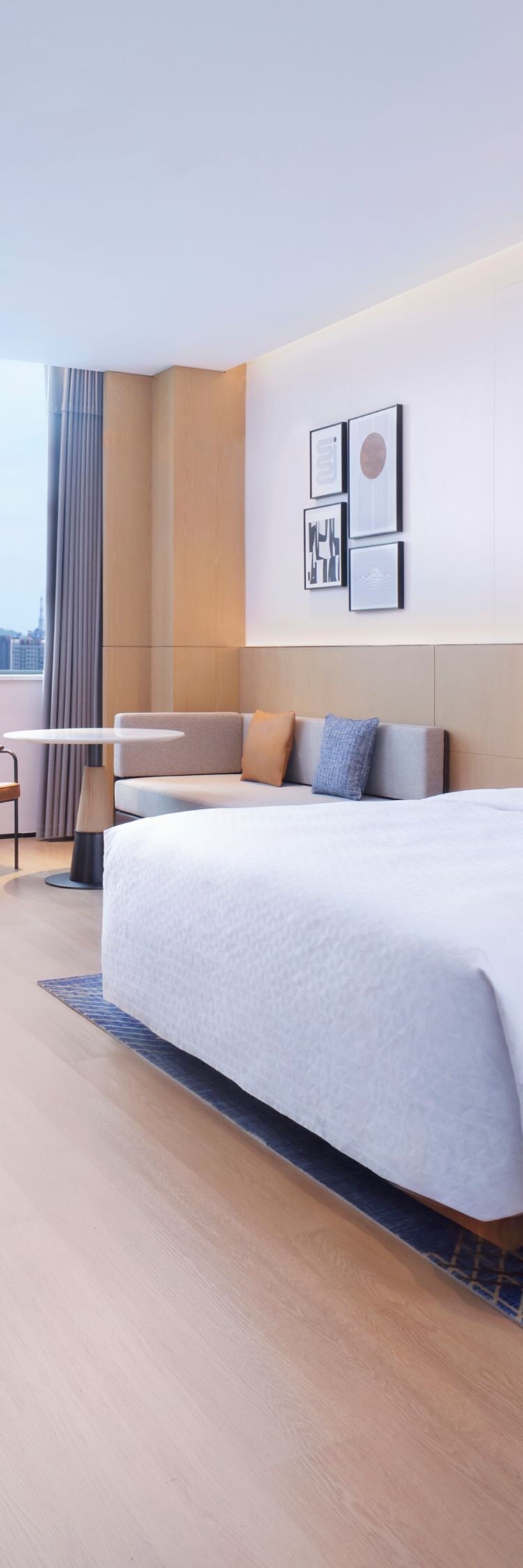 Suite with king bed, sitting area, and bench