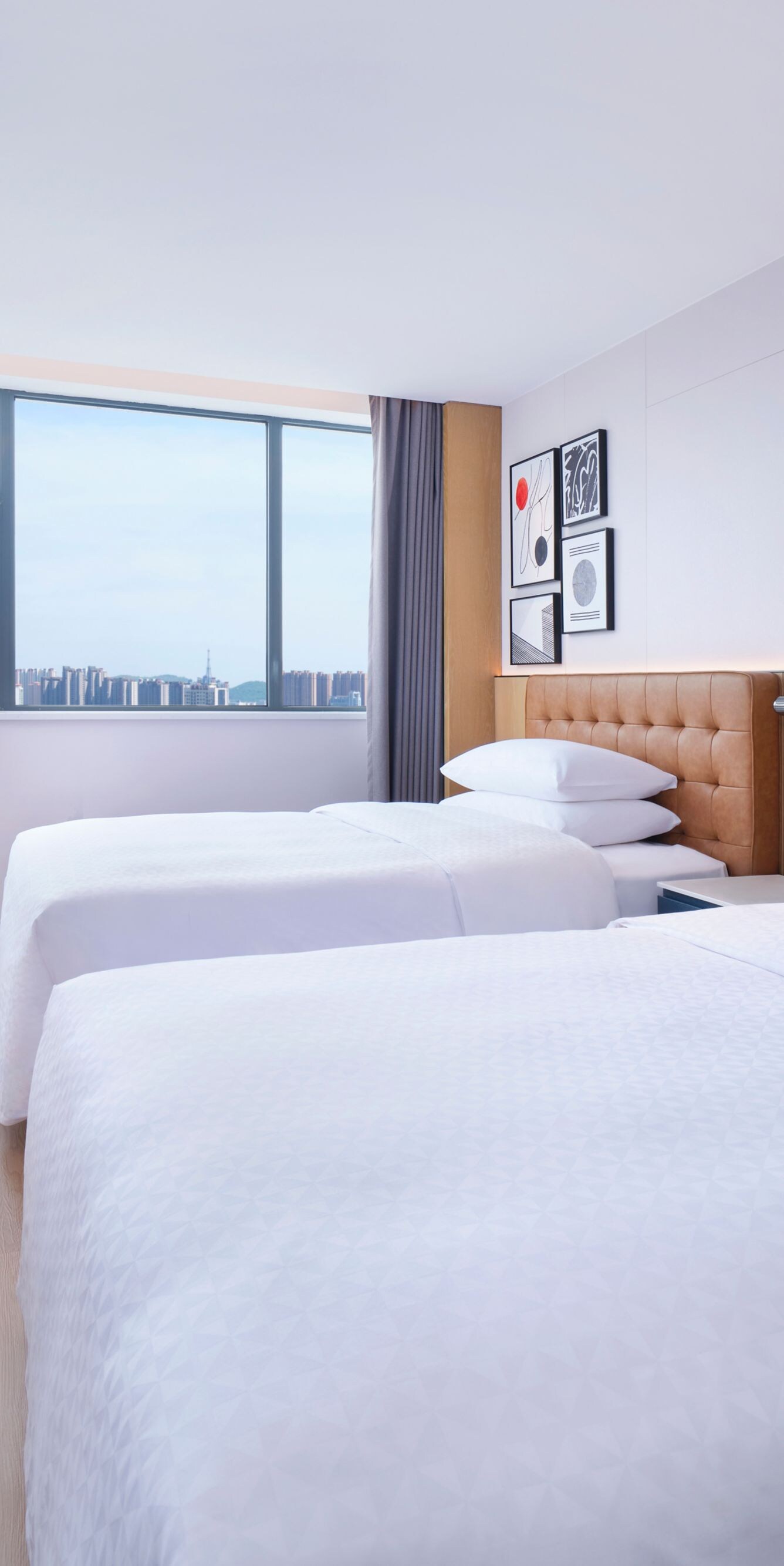 Modern hotel city-view twin room with two beds