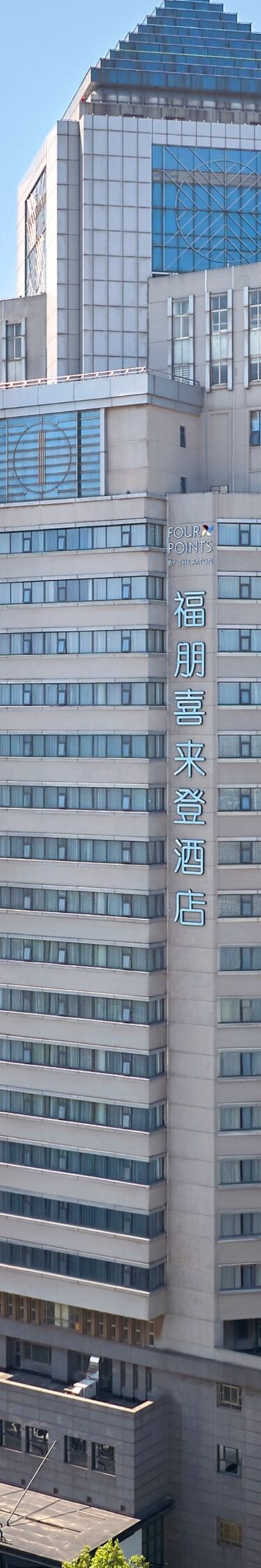 Modern hotel facade, glass windows, bright lights 