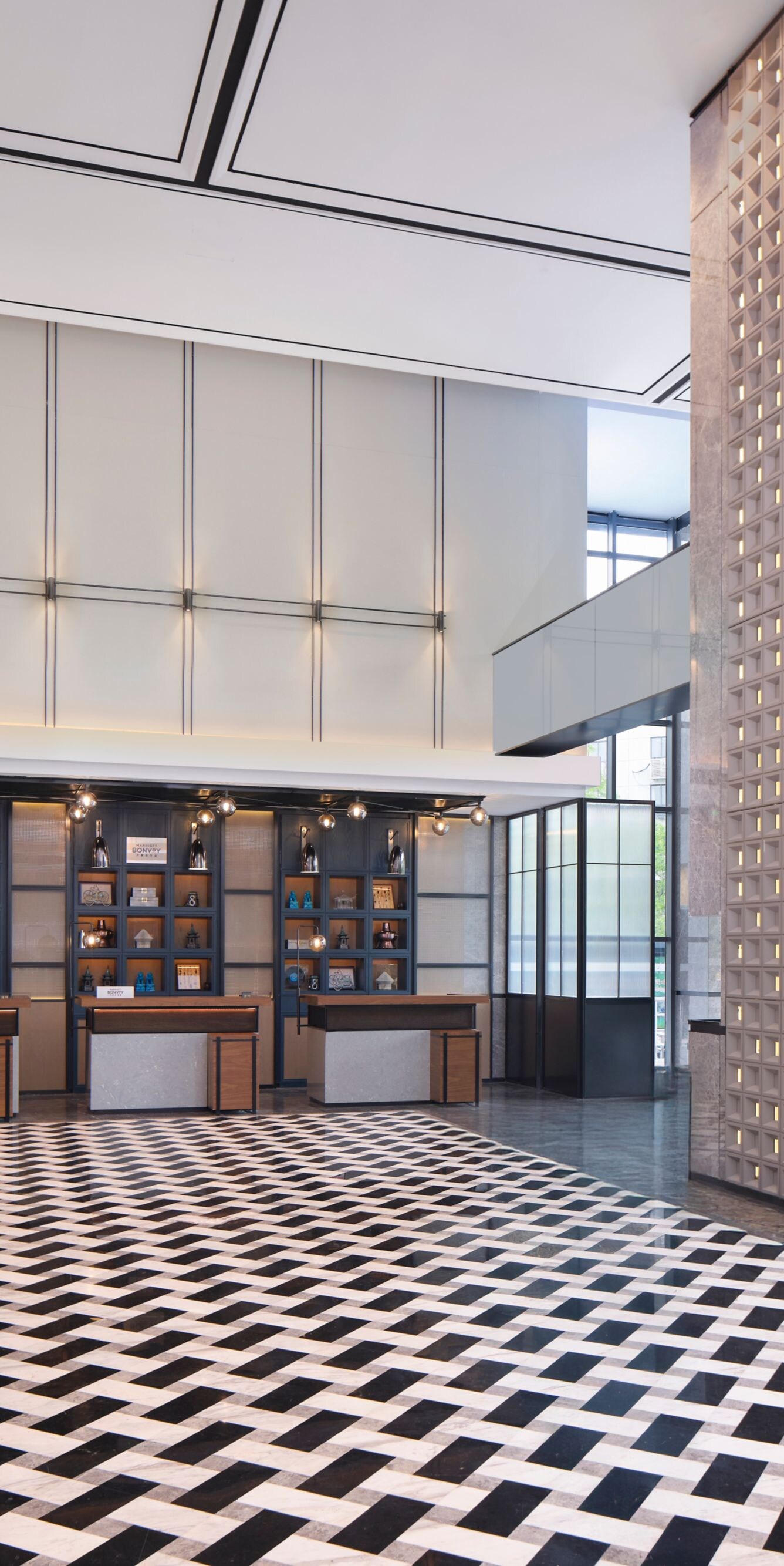 Spacious hotel lobby with front desks and tiles