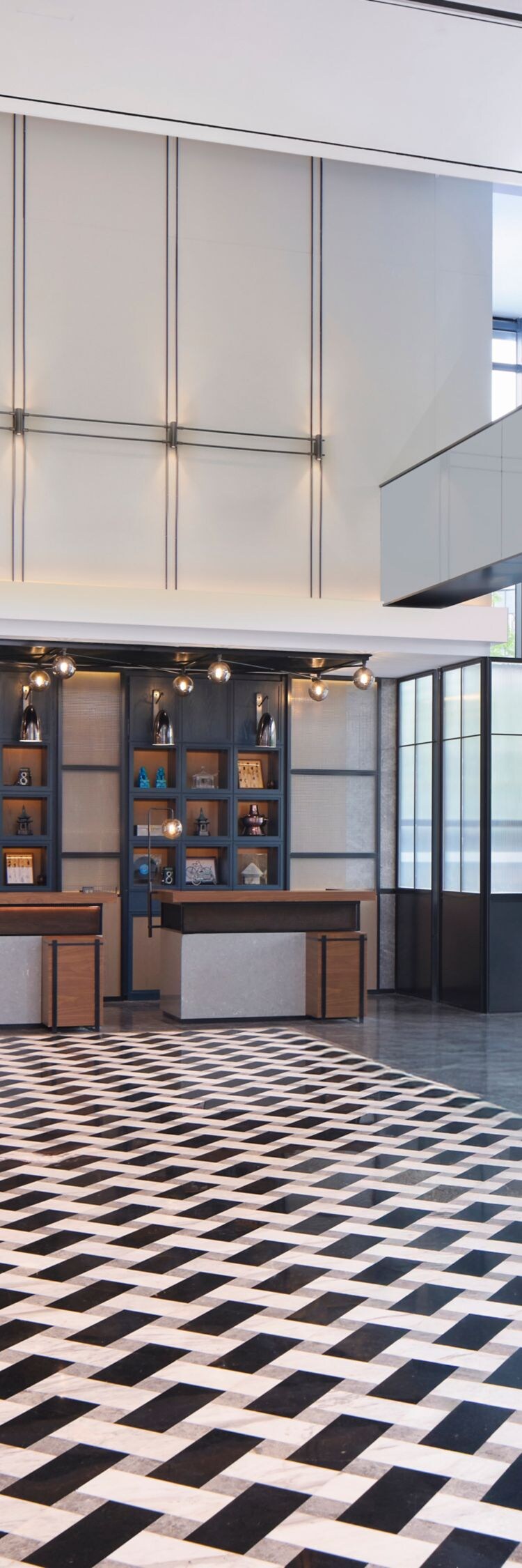 Spacious hotel lobby with front desks and tiles
