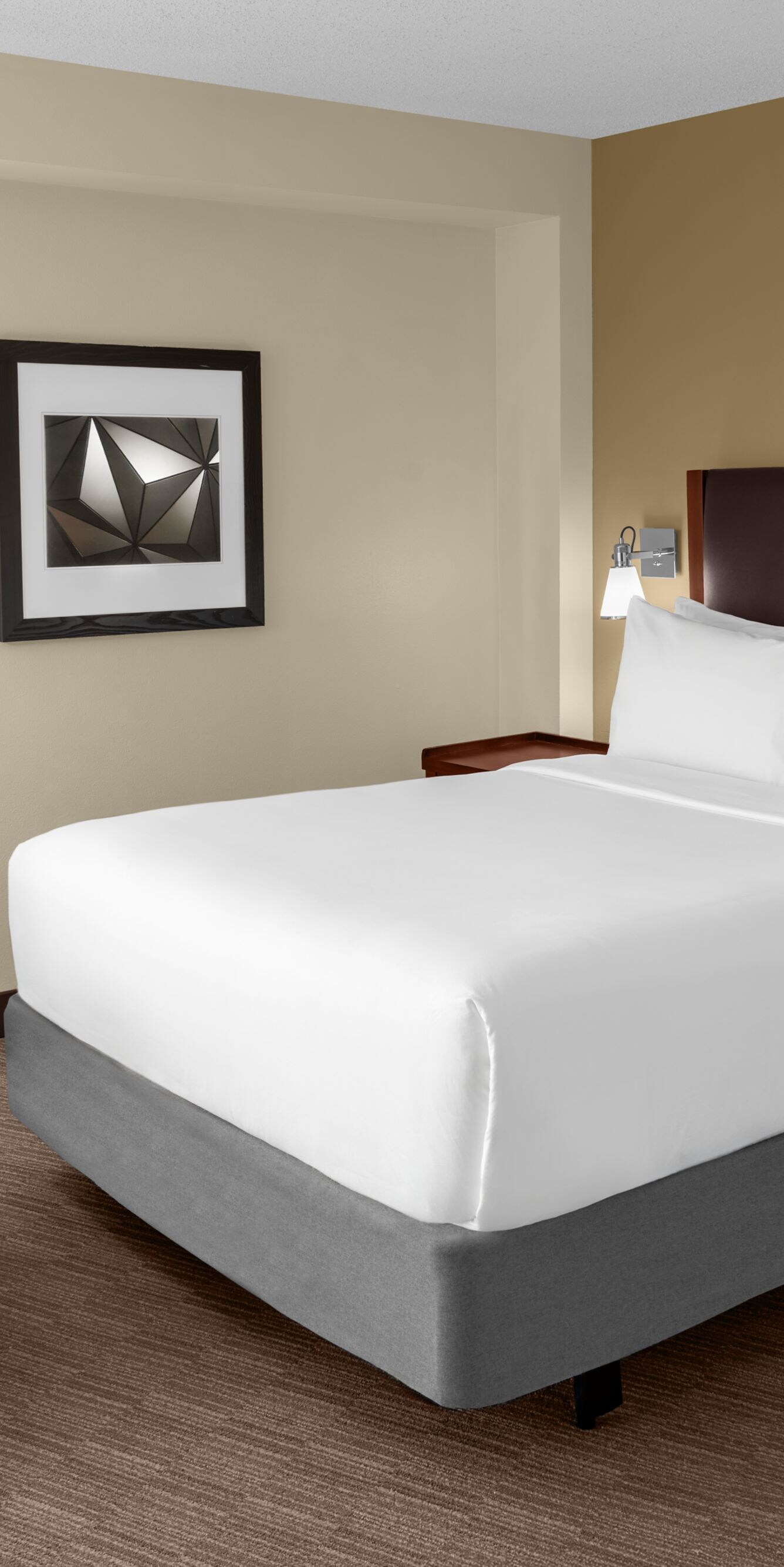 Queen guest room with bed and chair